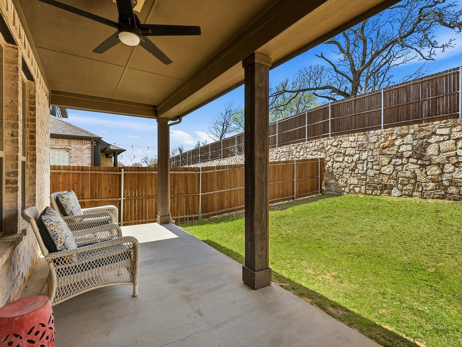 Covered back patio overlooking a private backyard