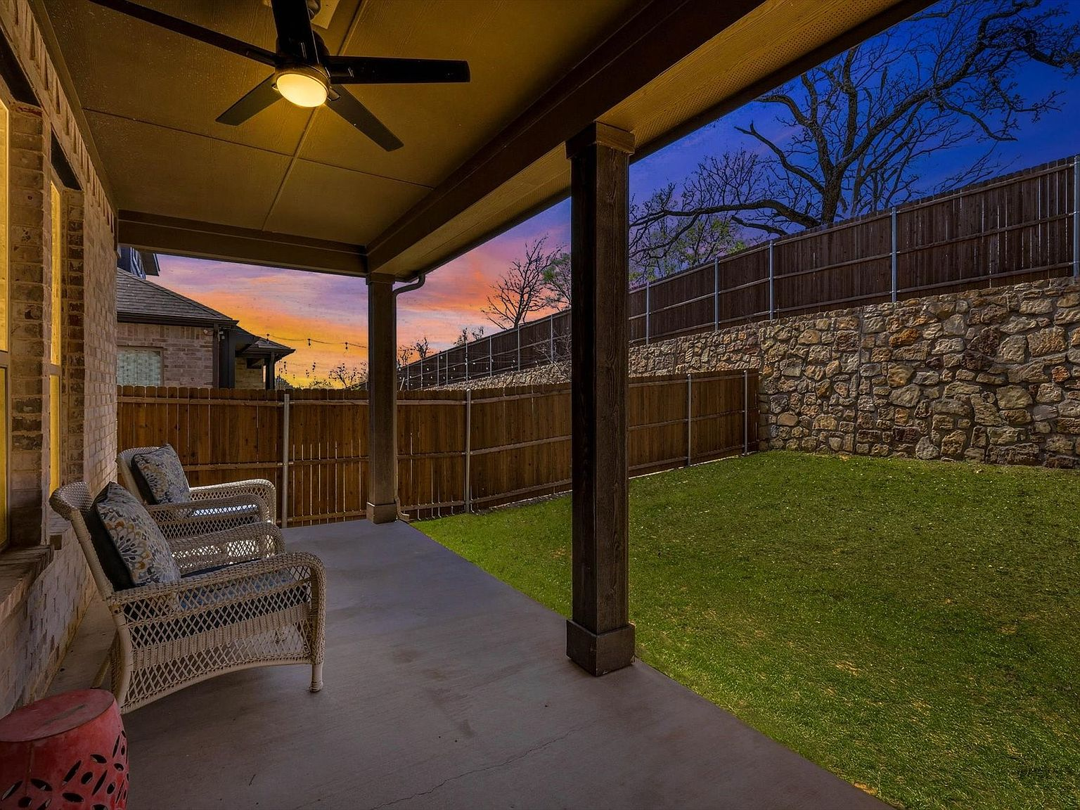 Back patio view at sunset with vivid purple and orange sky