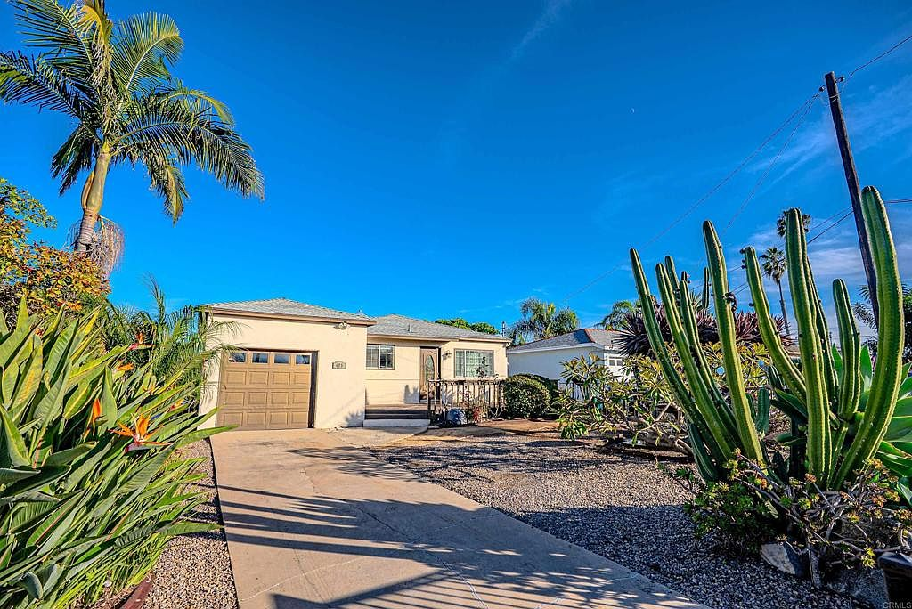 Front exterior of the ranch-style home with xeriscaped yard