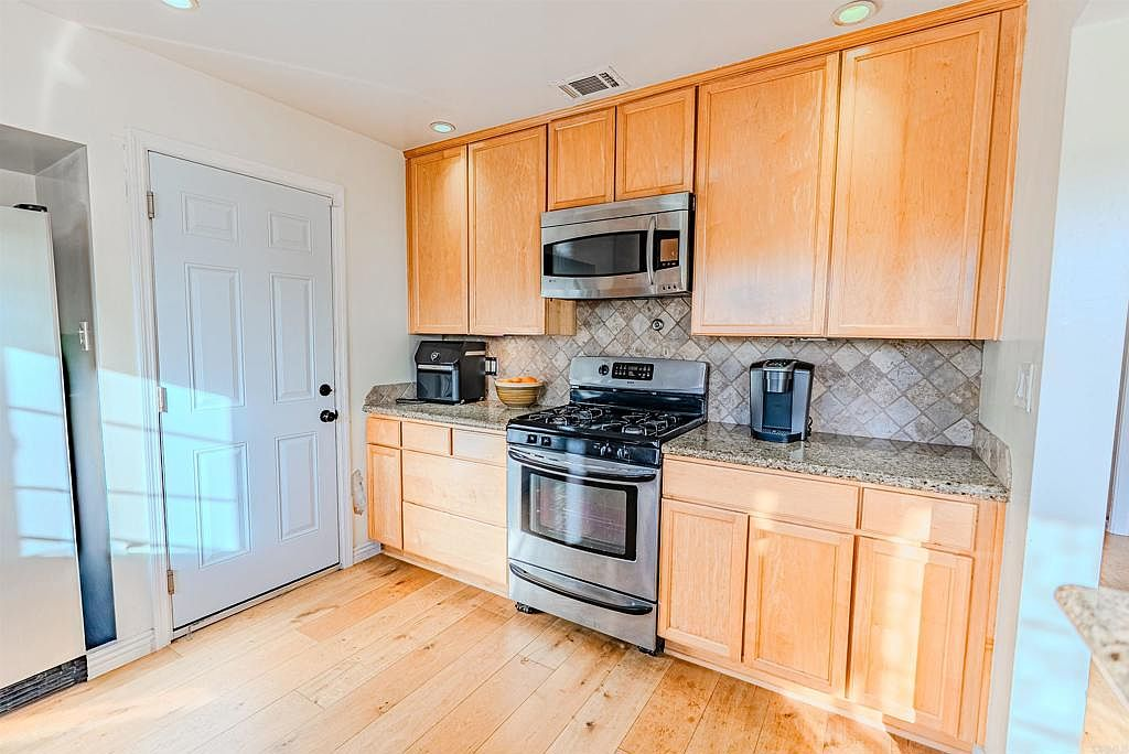 Kitchen with updated wood cabinetry and stainless steel appliances