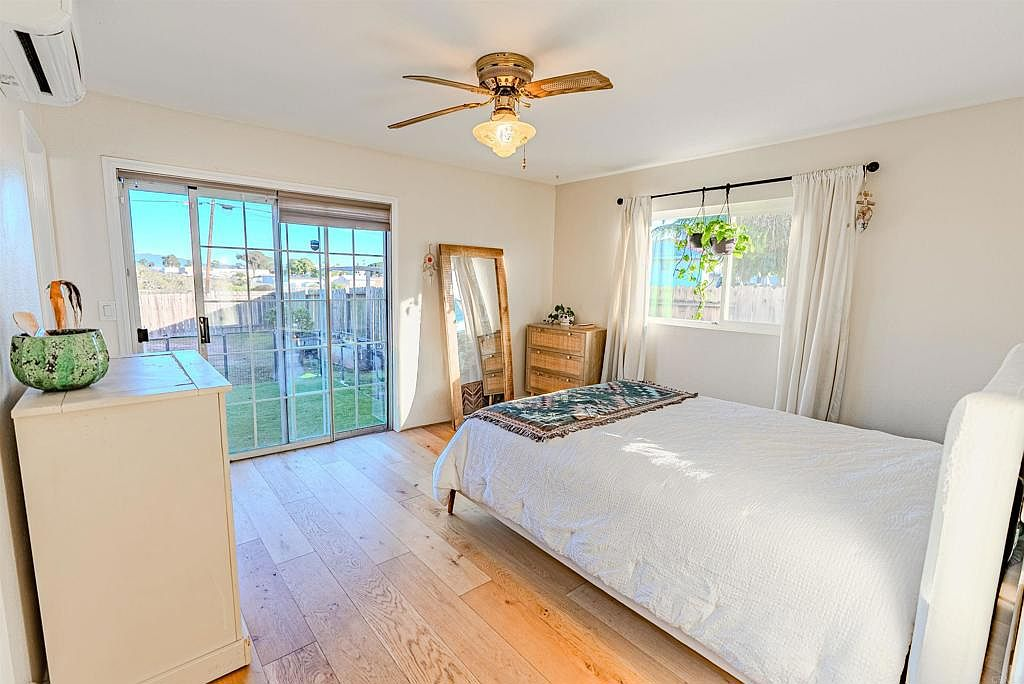 Primary bedroom with sliding glass doors opening to bay views