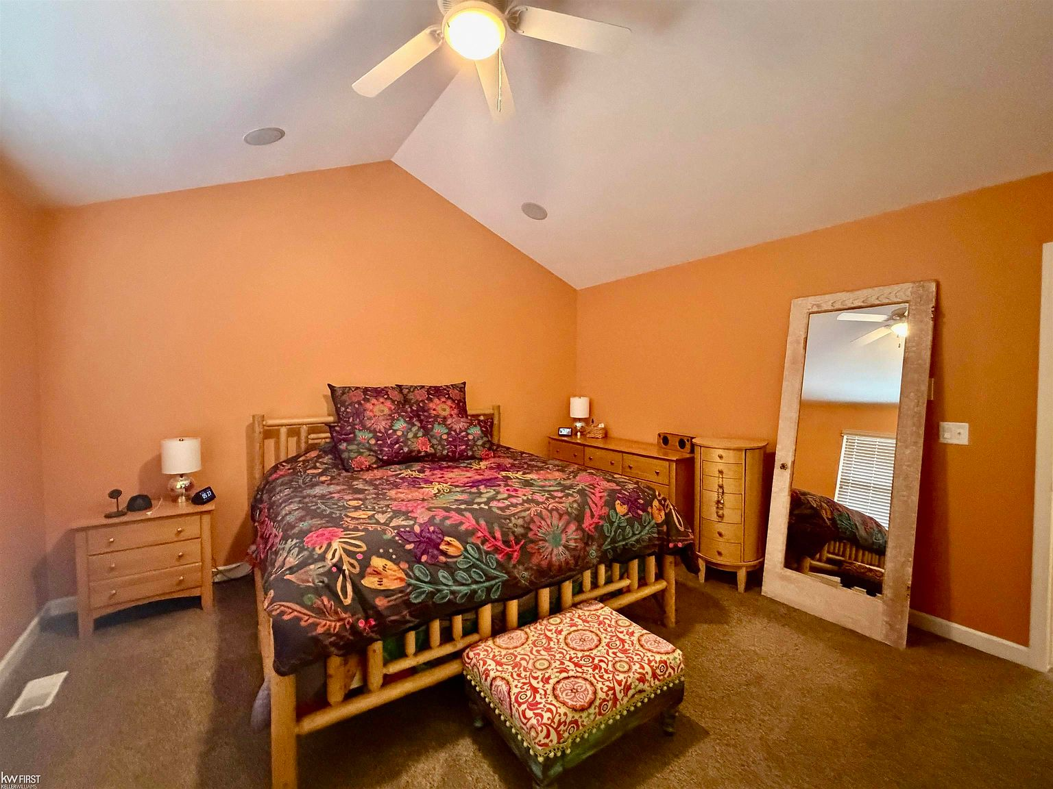 Primary bedroom with vaulted ceiling