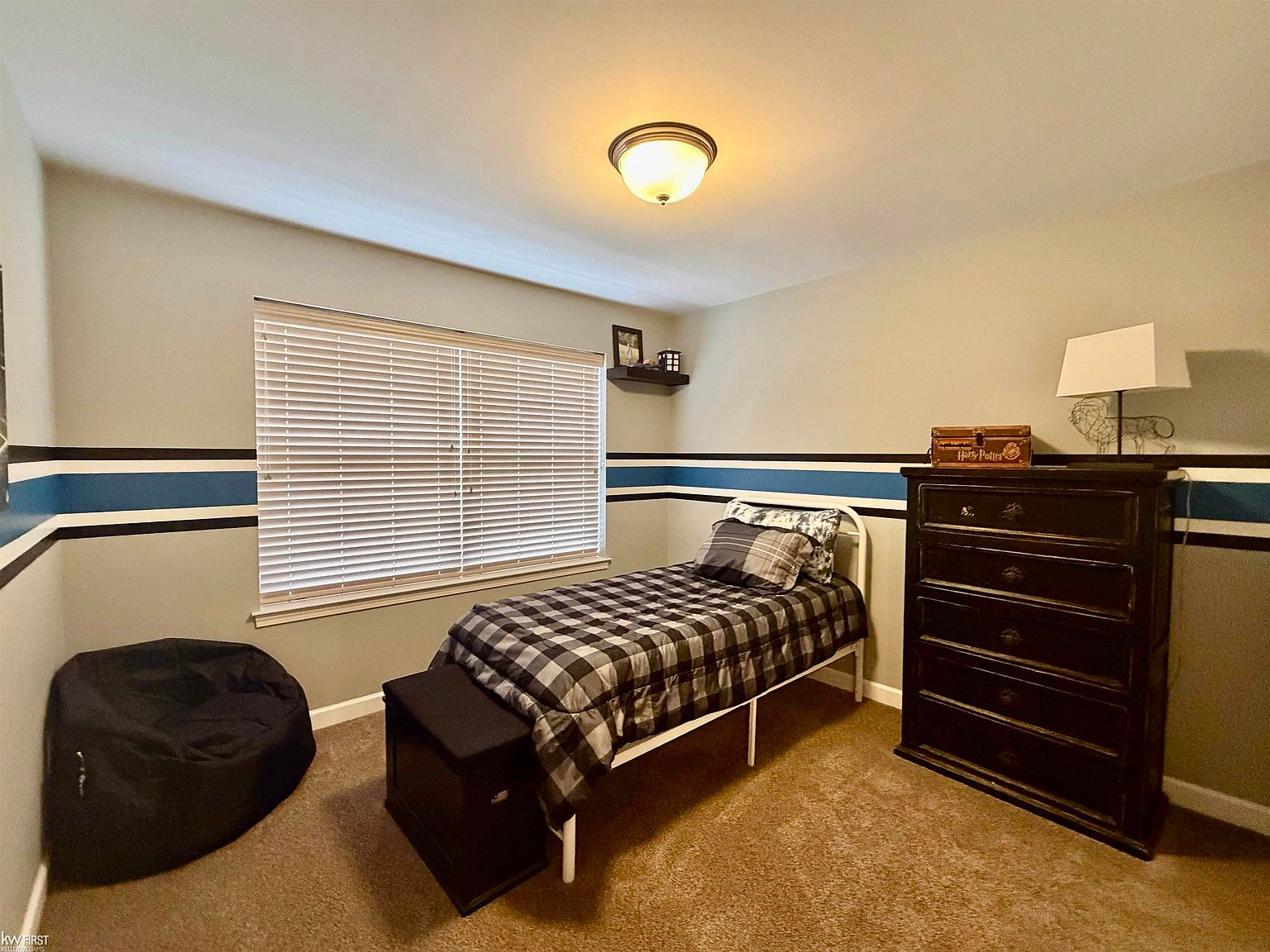 Secondary bedroom with blue striped accent wall
