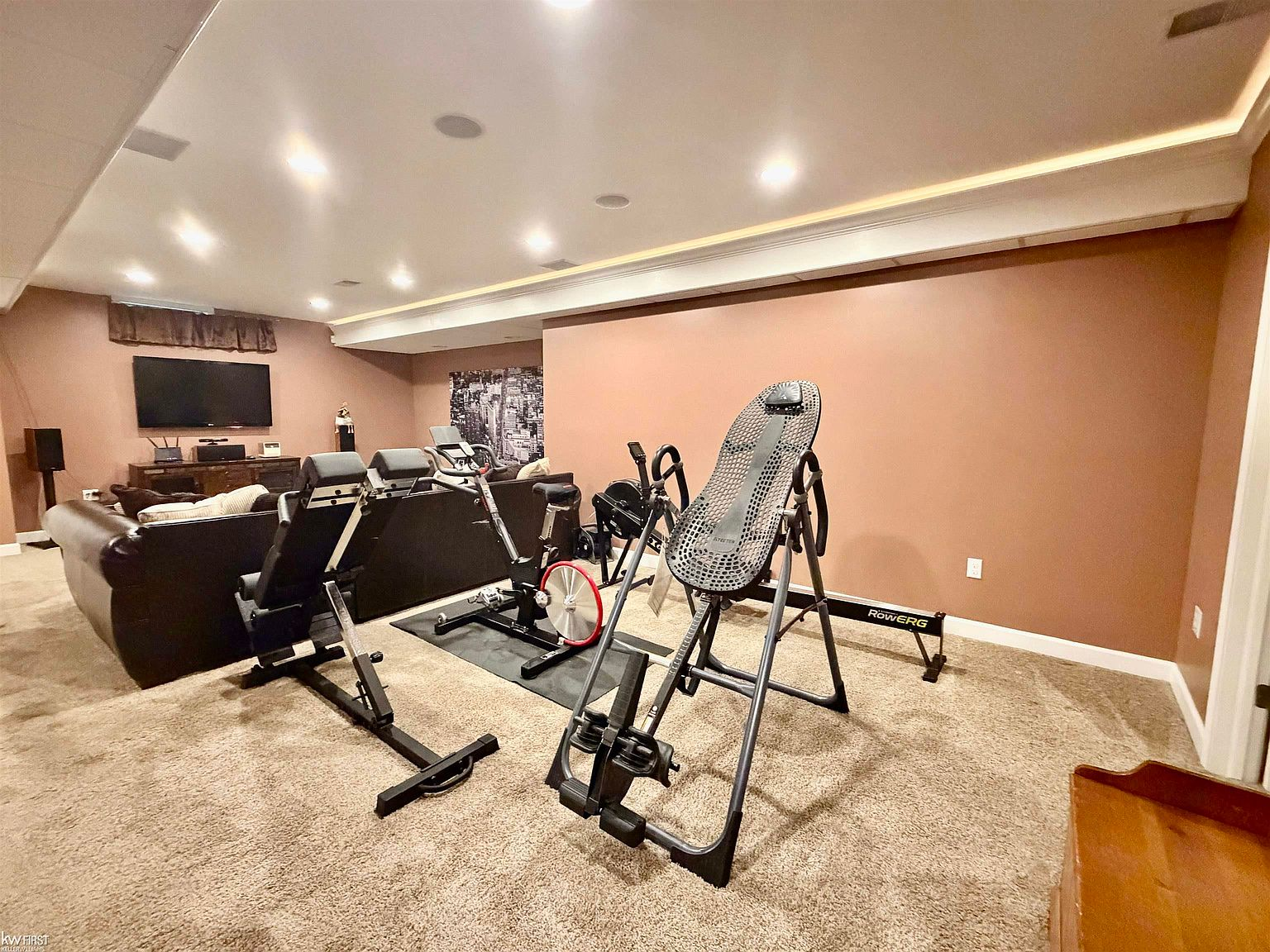 Basement workout area with exercise equipment