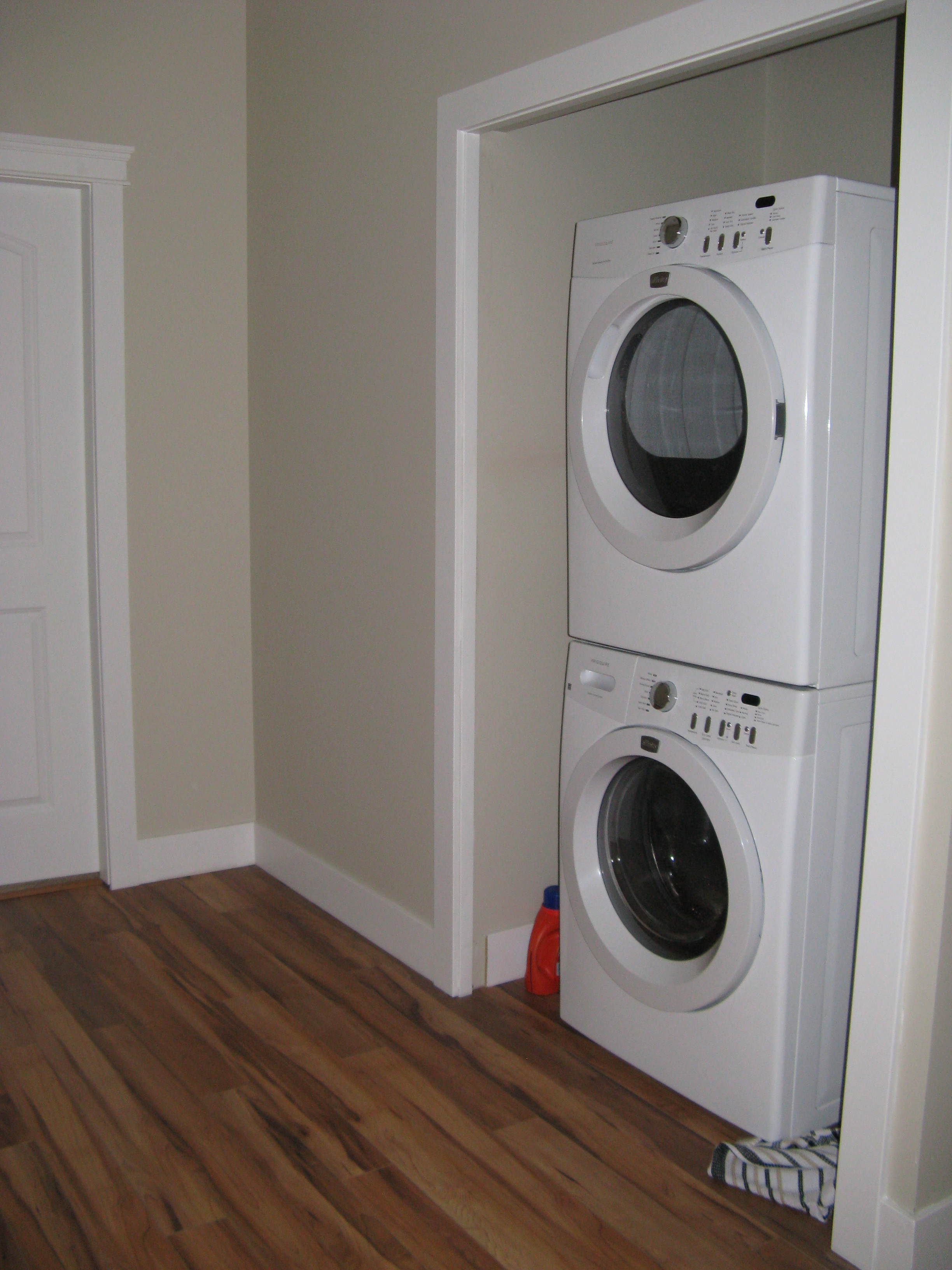 Stacked washer and dryer in laundry closet niche