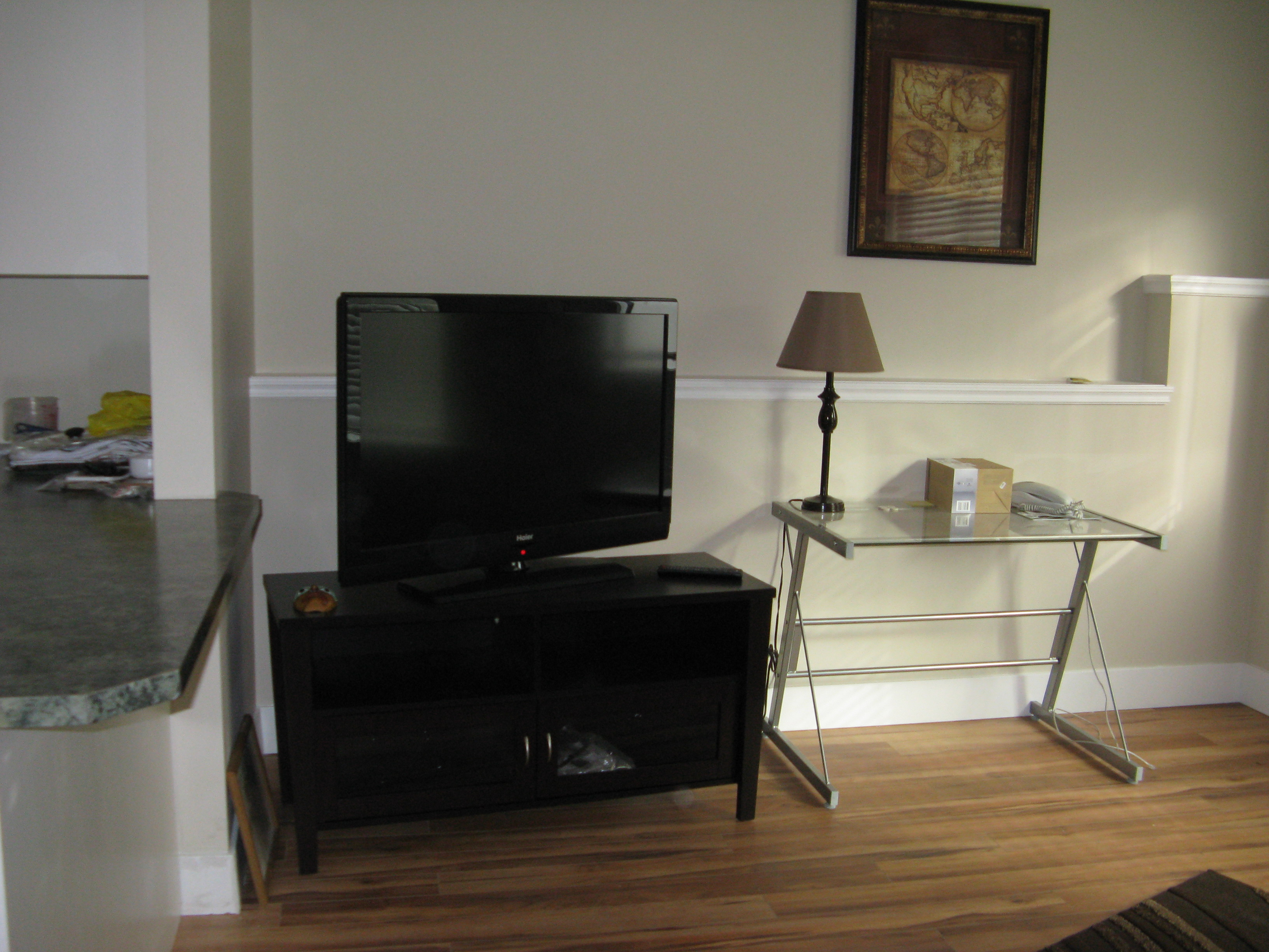Living room corner adjacent to kitchen counter with natural daylight