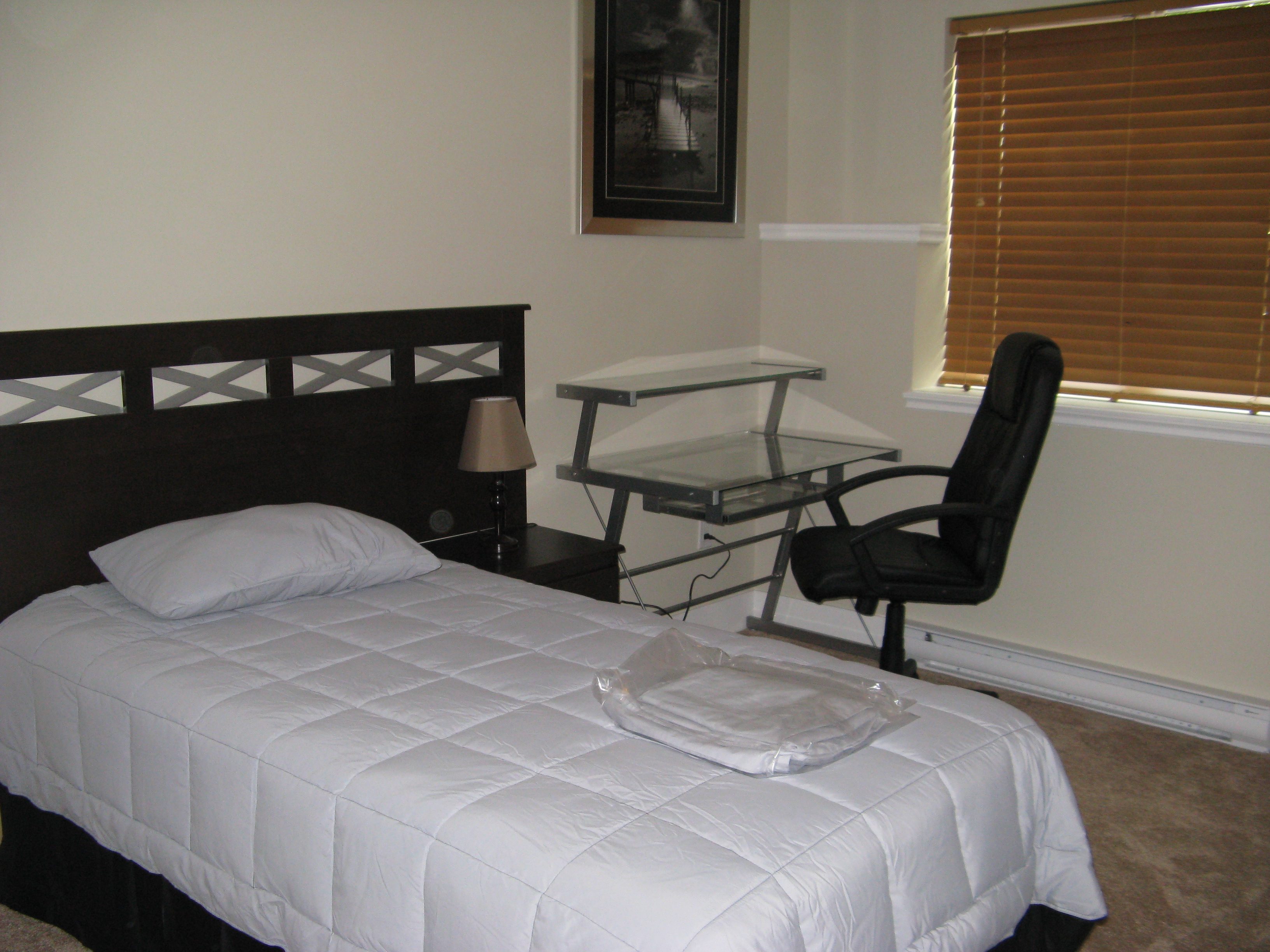 Bedroom configured as office workspace with desk and chair
