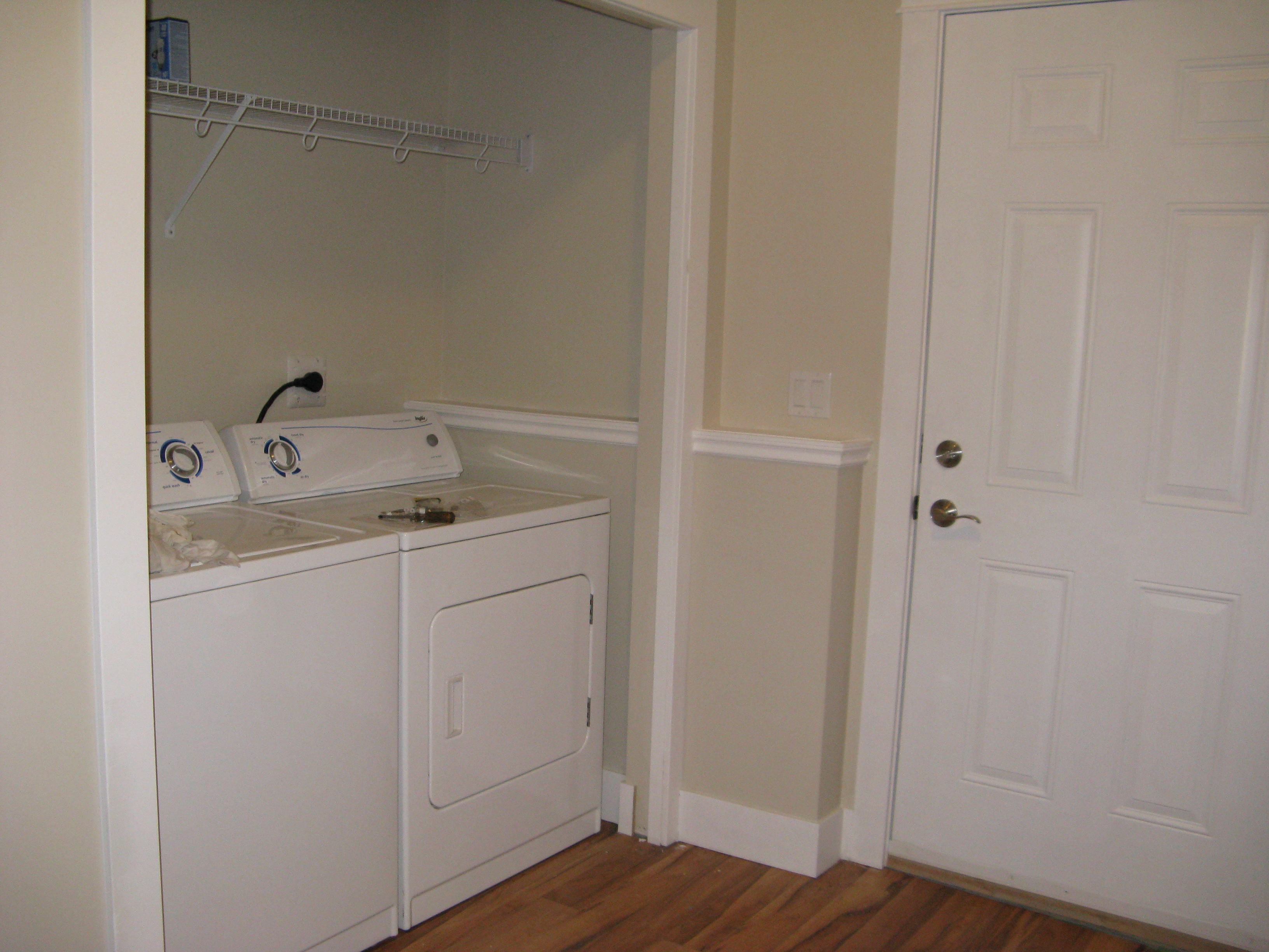 Laundry room with front-loading washer and top-loading dryer