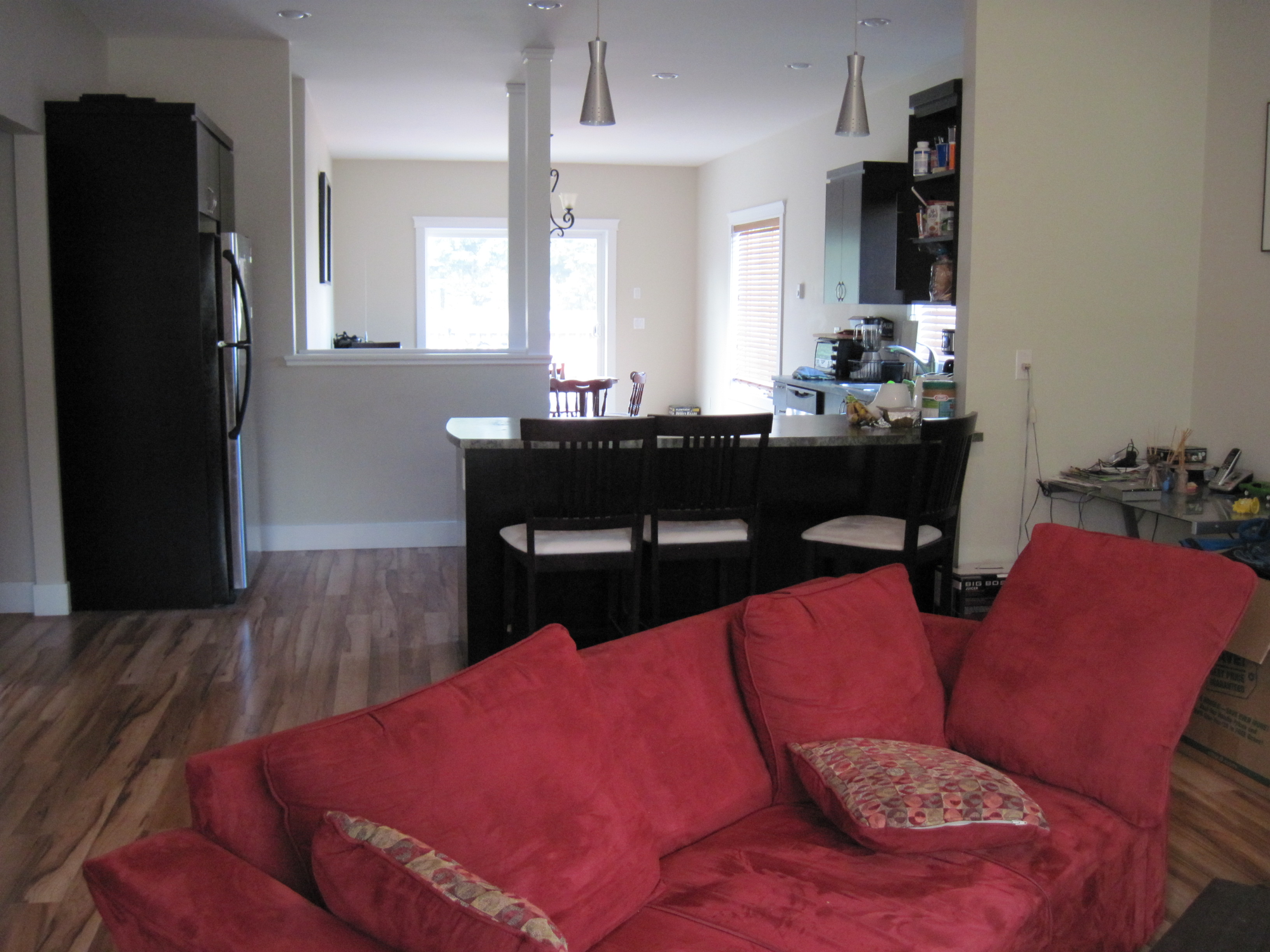 Open-concept living room looking into kitchen and dining area