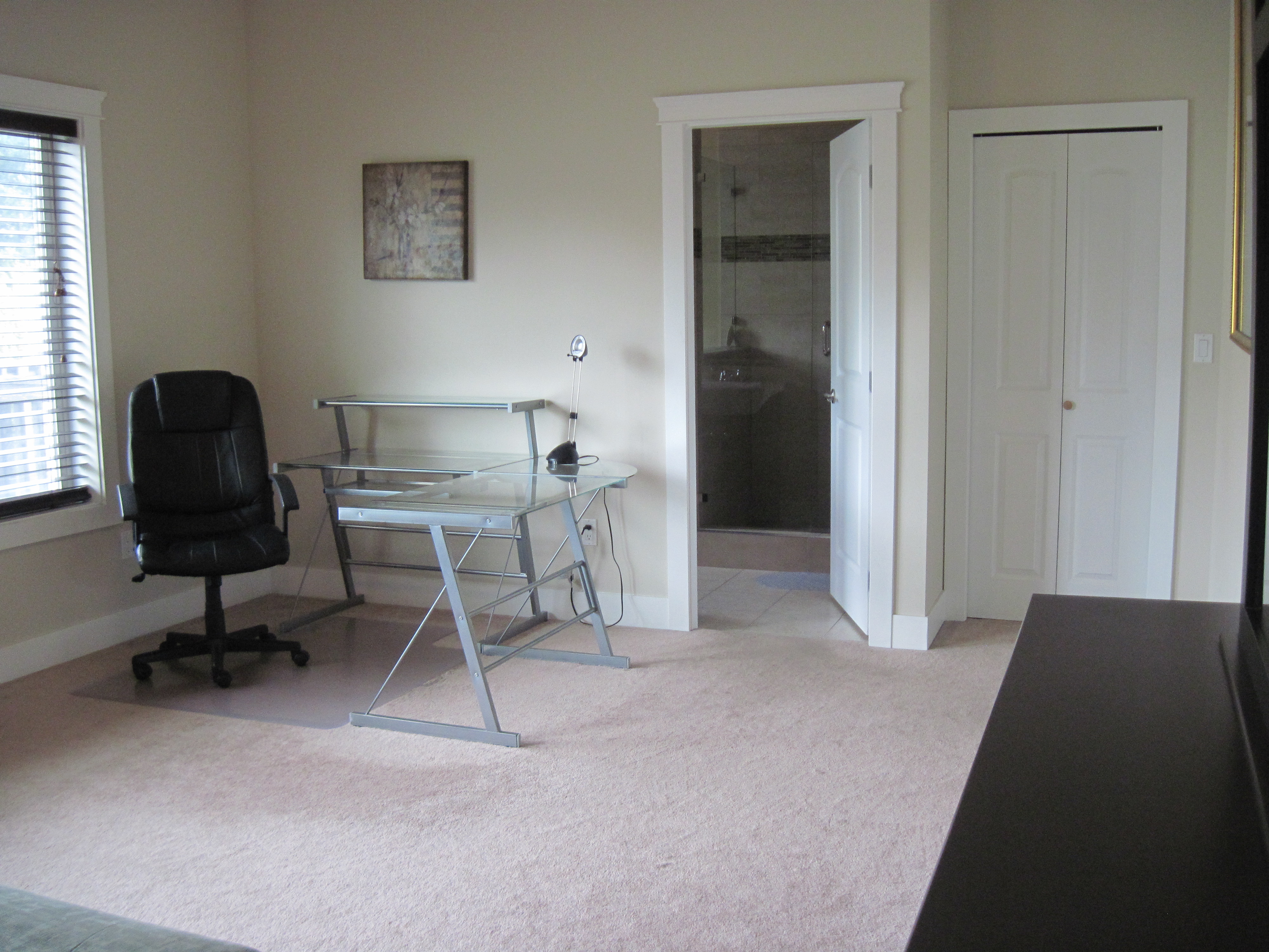 Bedroom configured as home office with attached bathroom view