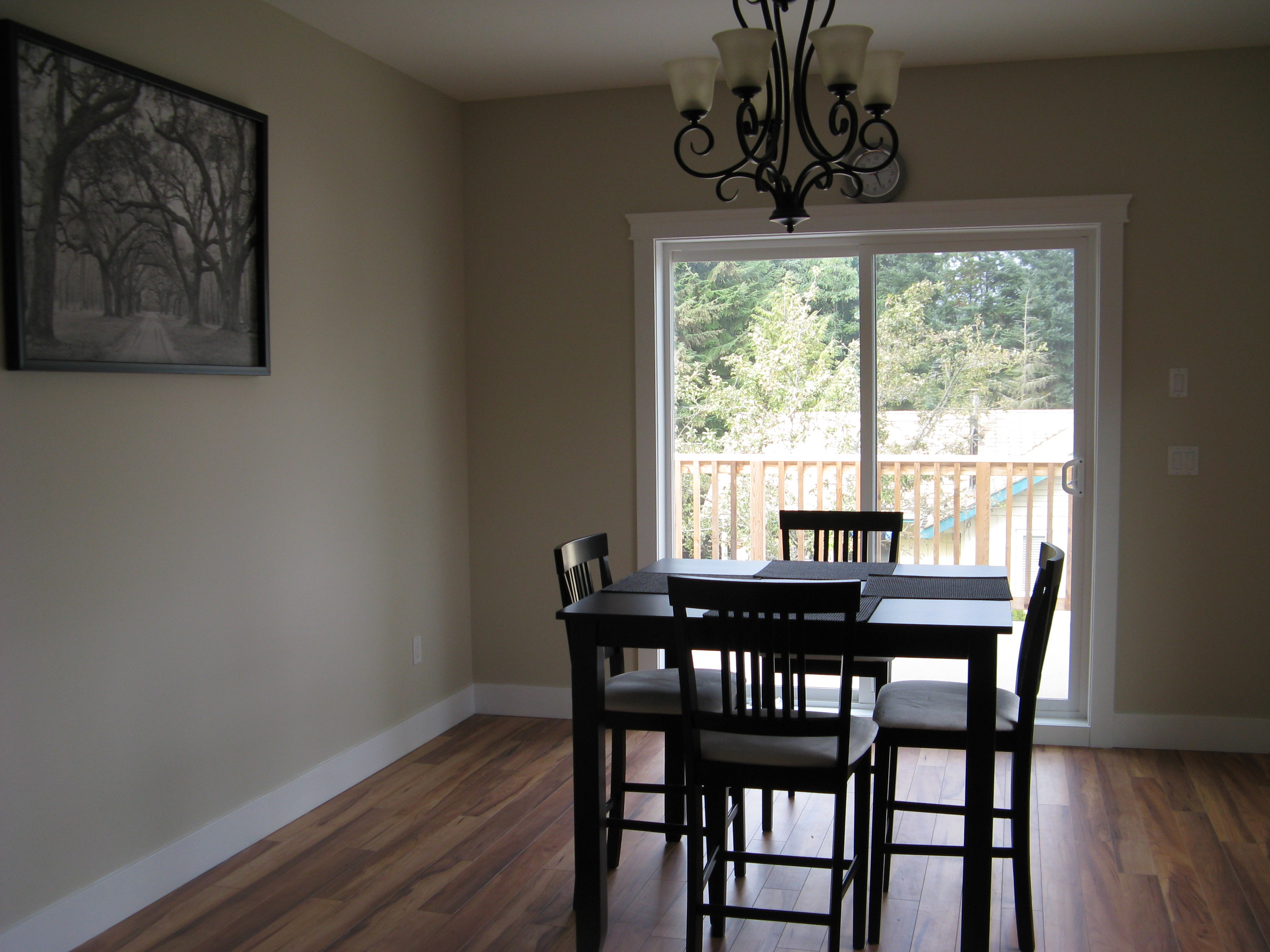 Dining room with dark wood table and sliding glass door to deck