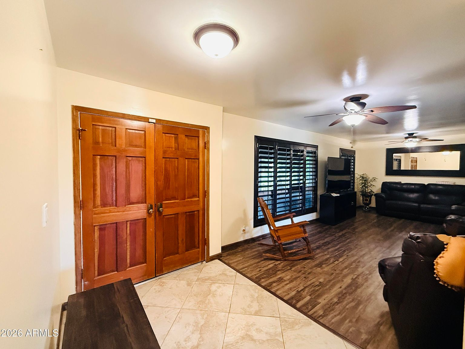 Entryway opening into the living room with tiled foyer