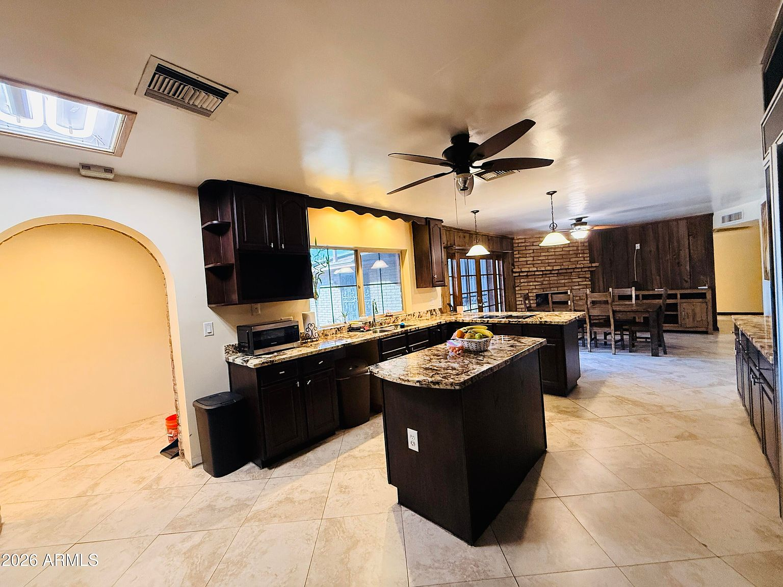 Kitchen opening to dining area with island