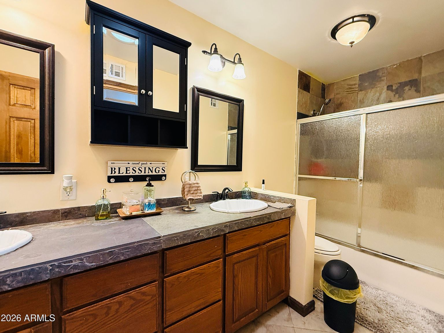 Bathroom with double vanity and slate tile shower
