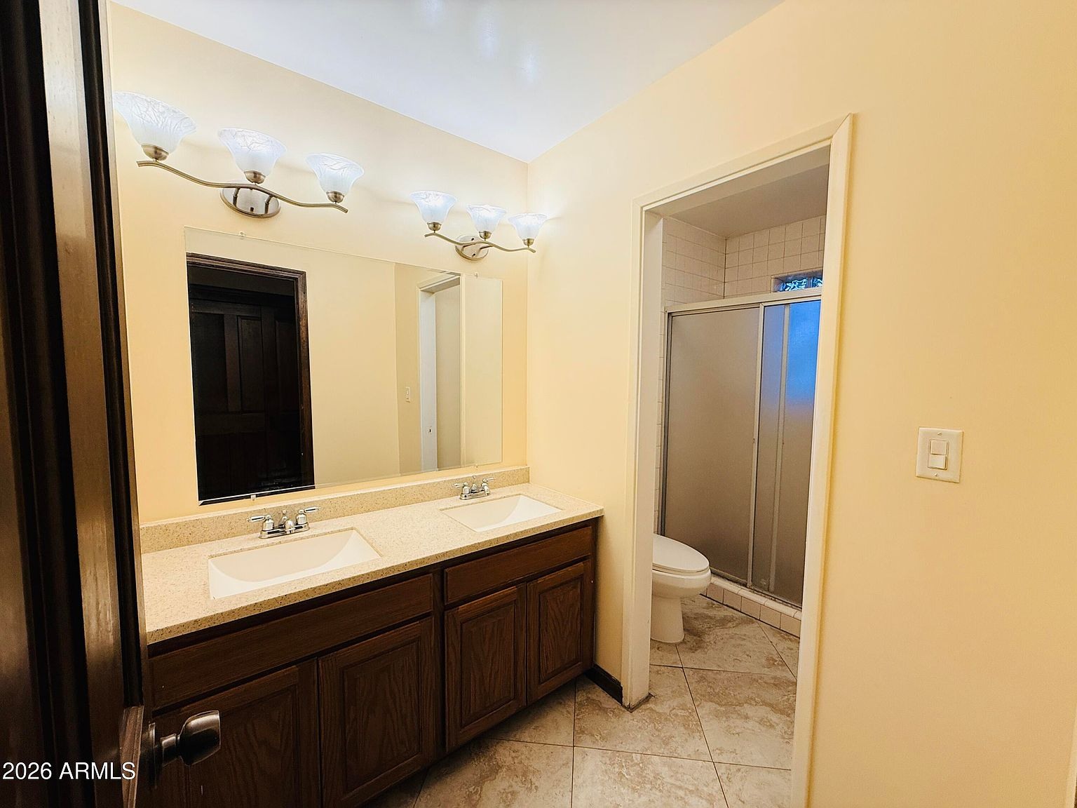 Bathroom with double sink vanity and tile flooring