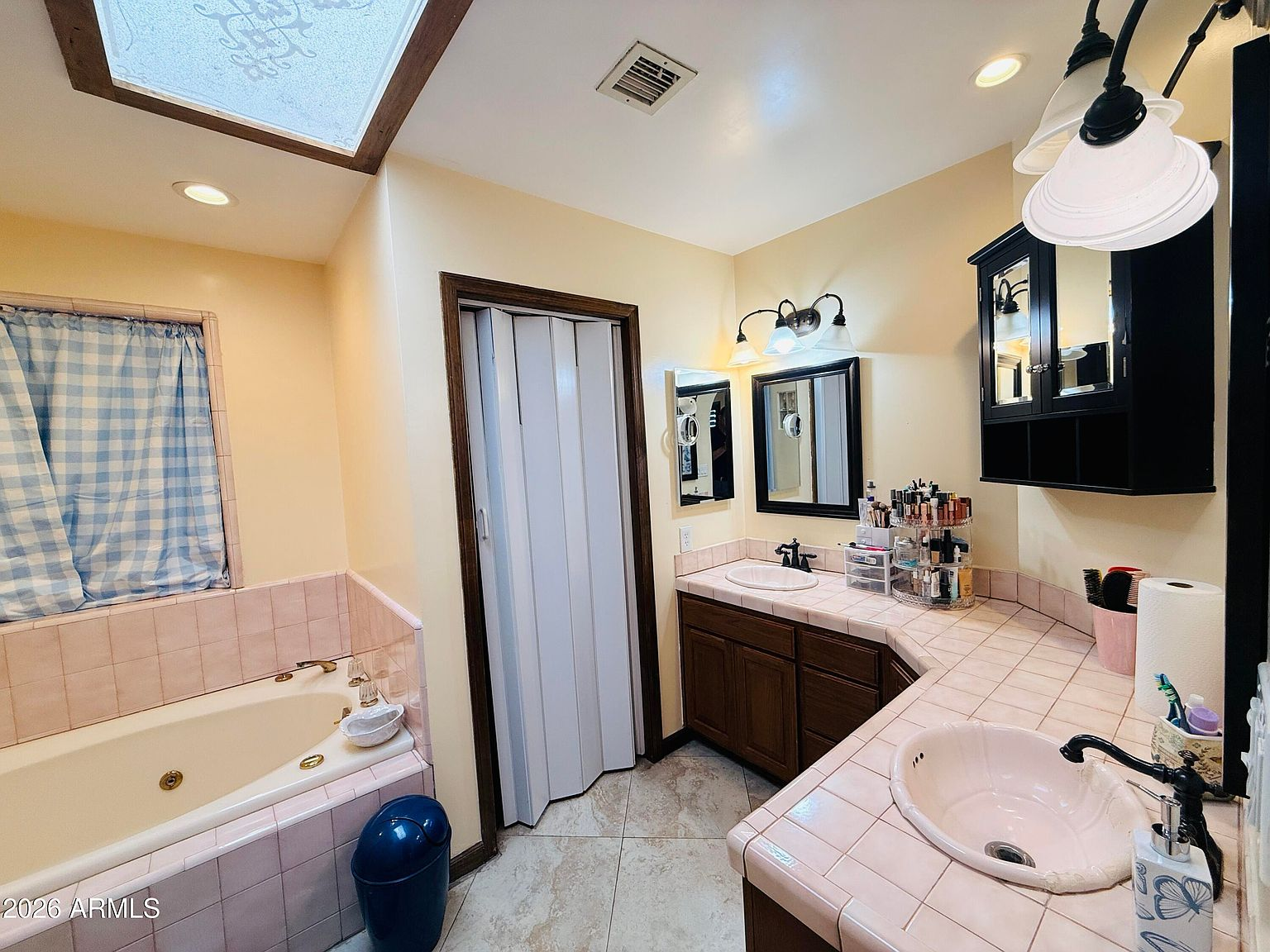 Bathroom with soaking tub and skylight