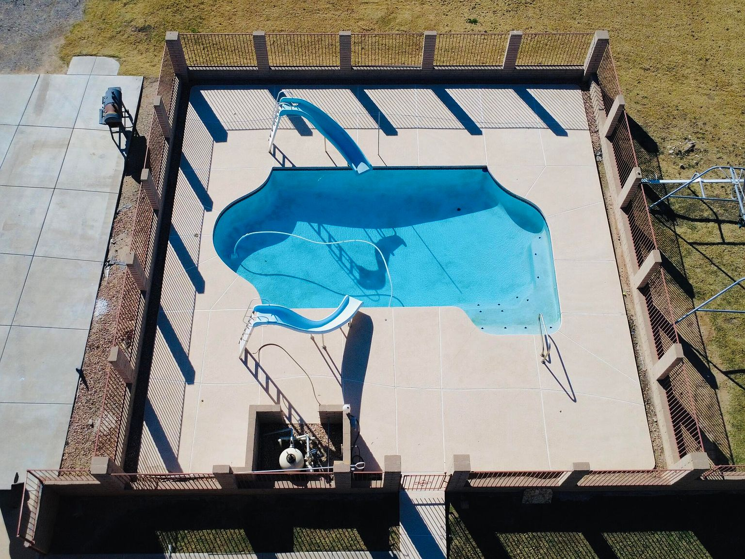 Aerial top-down view of the fenced swimming pool