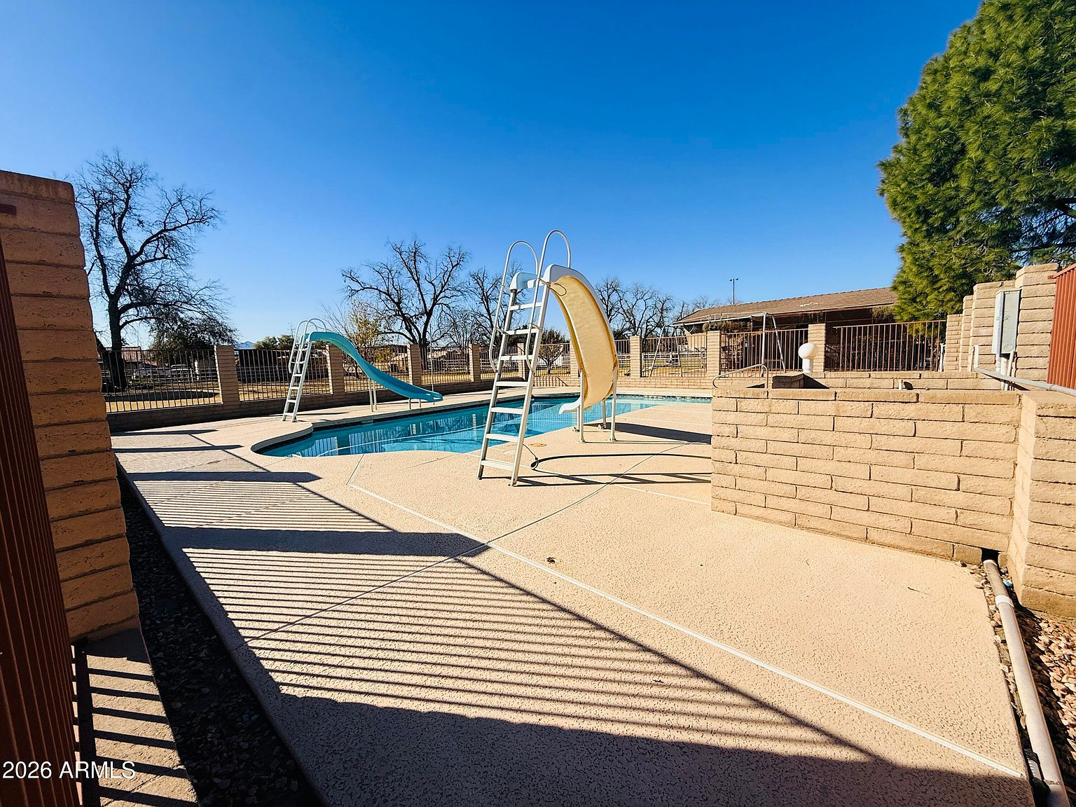Backyard pool with two water slides