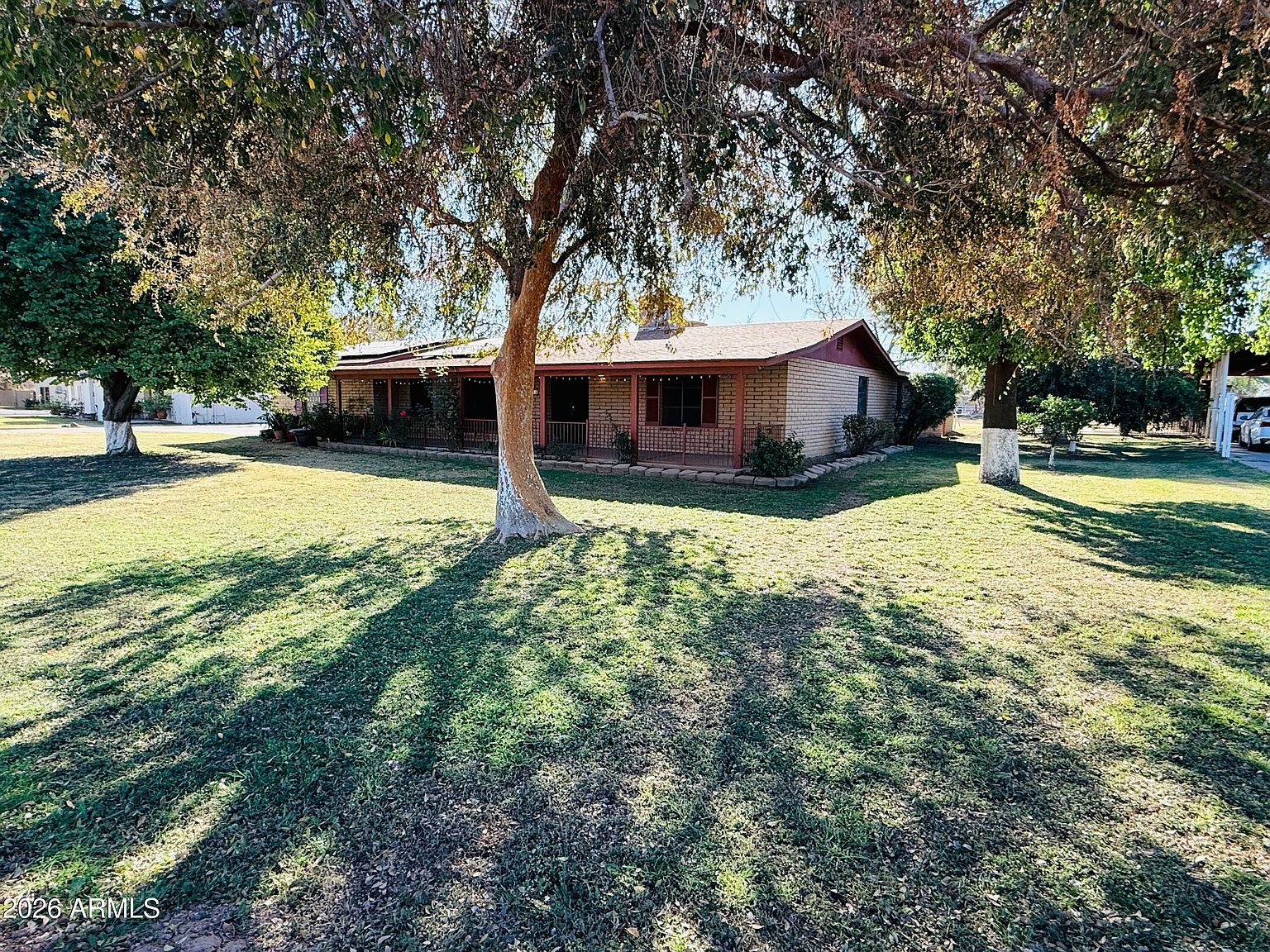 Front yard with covered porch and mature trees