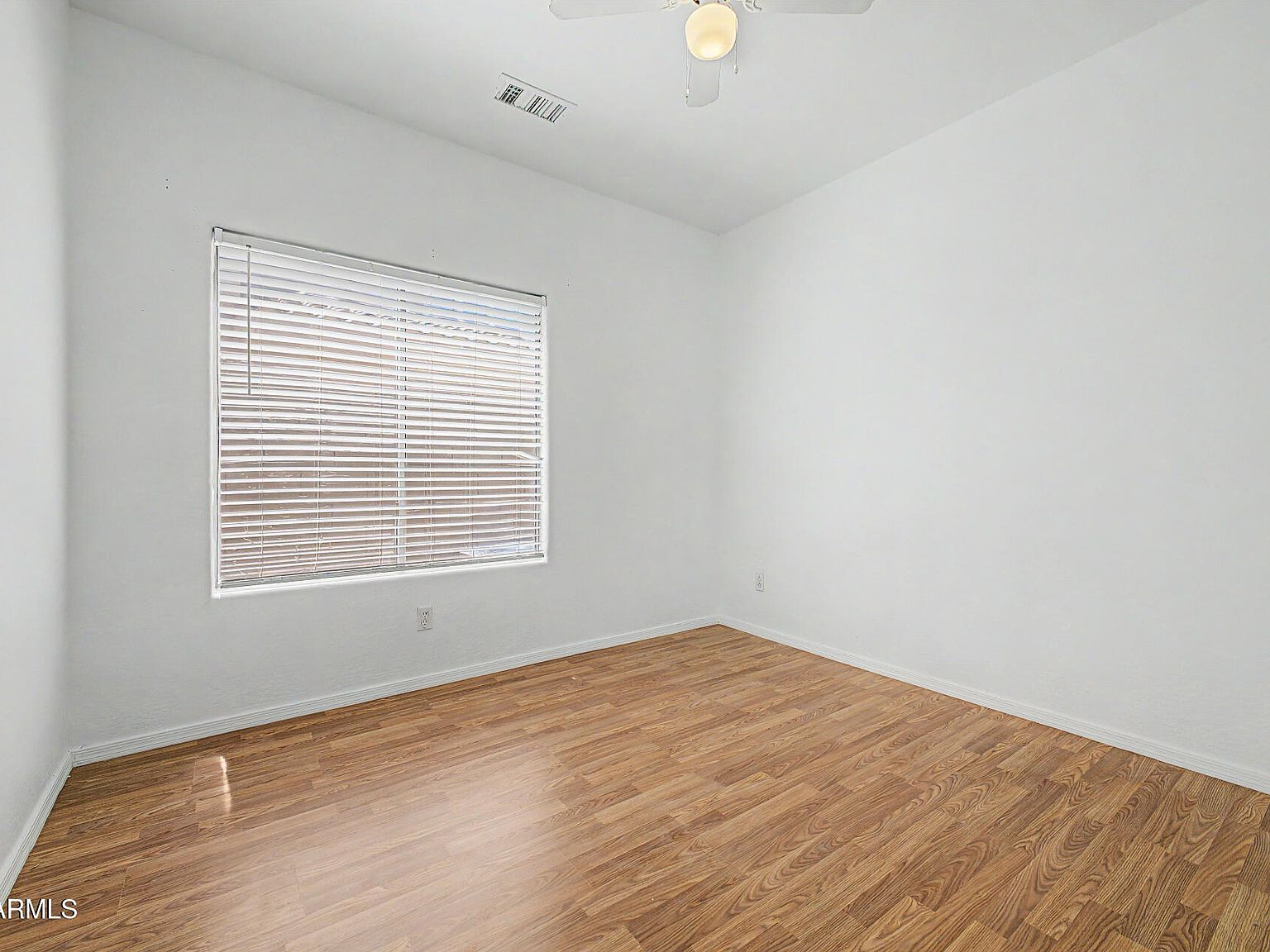 Bedroom with wood-look flooring and ceiling fan