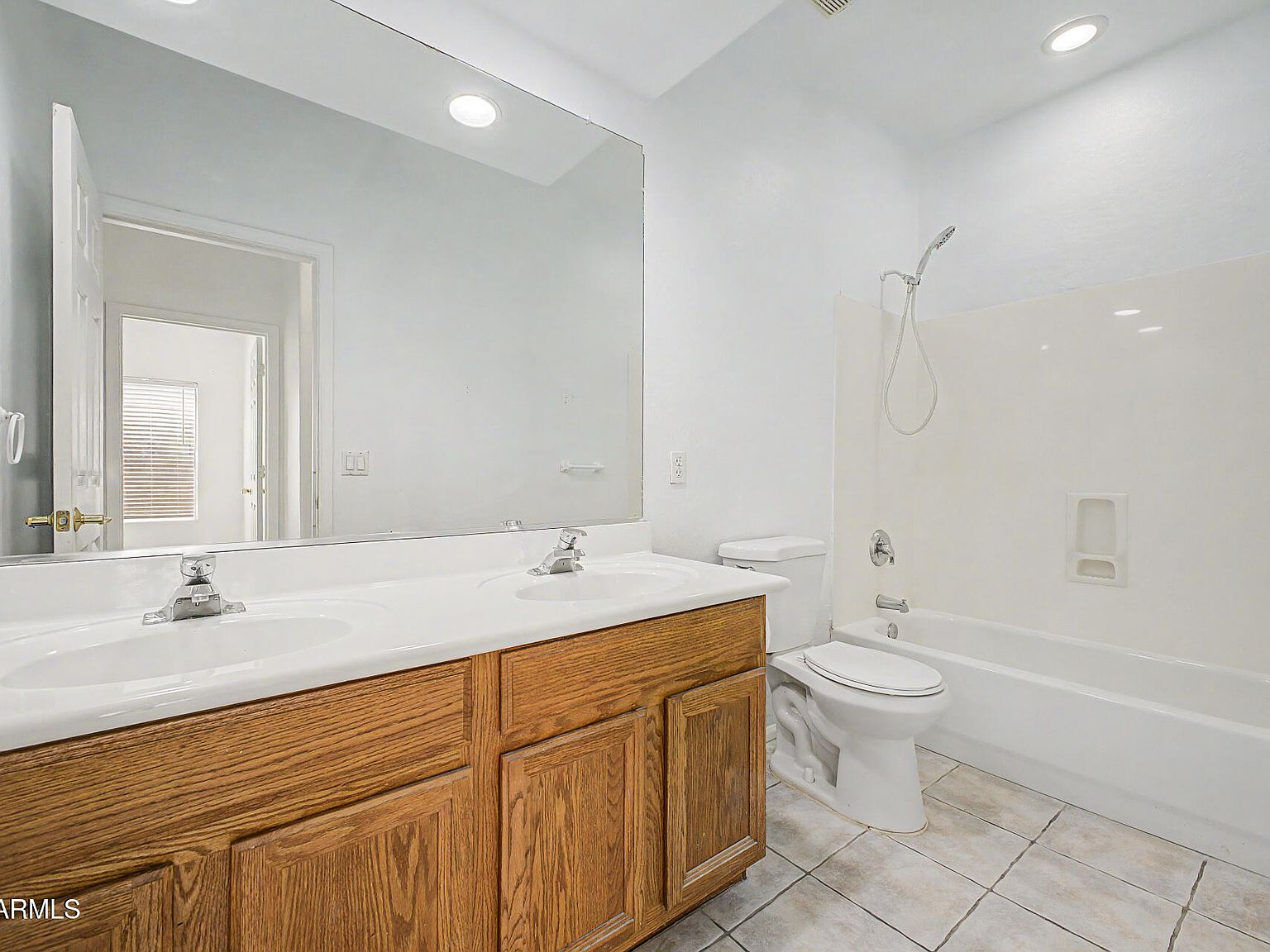Guest bathroom with double vanity and standard tub-shower combo