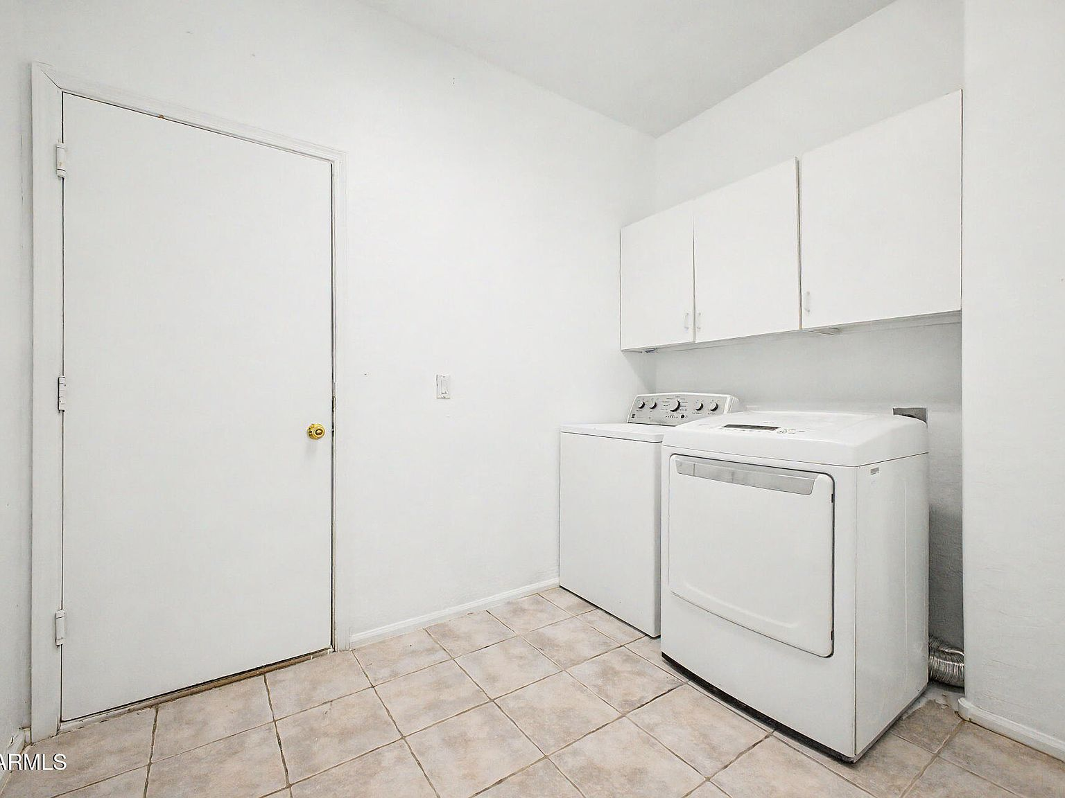 Laundry room with washer and dryer and overhead cabinets