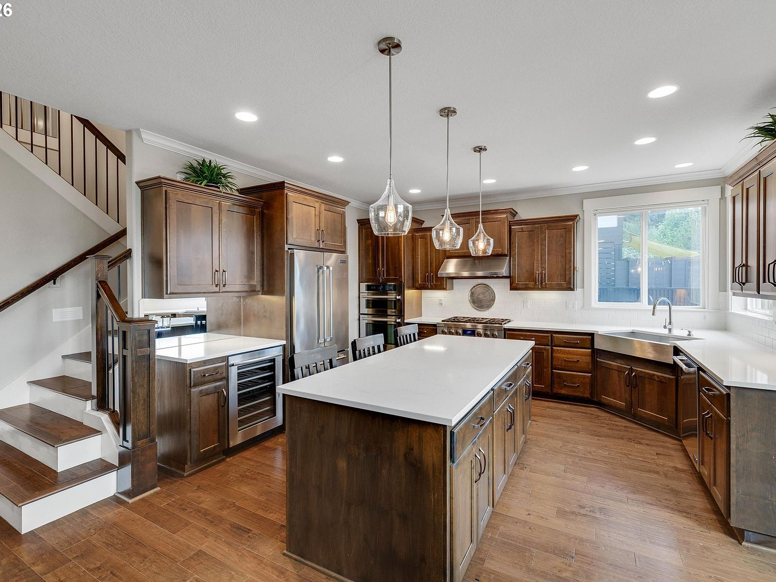 Craftsman-style kitchen with medium-toned wood cabinetry, center island, and hardwood floors