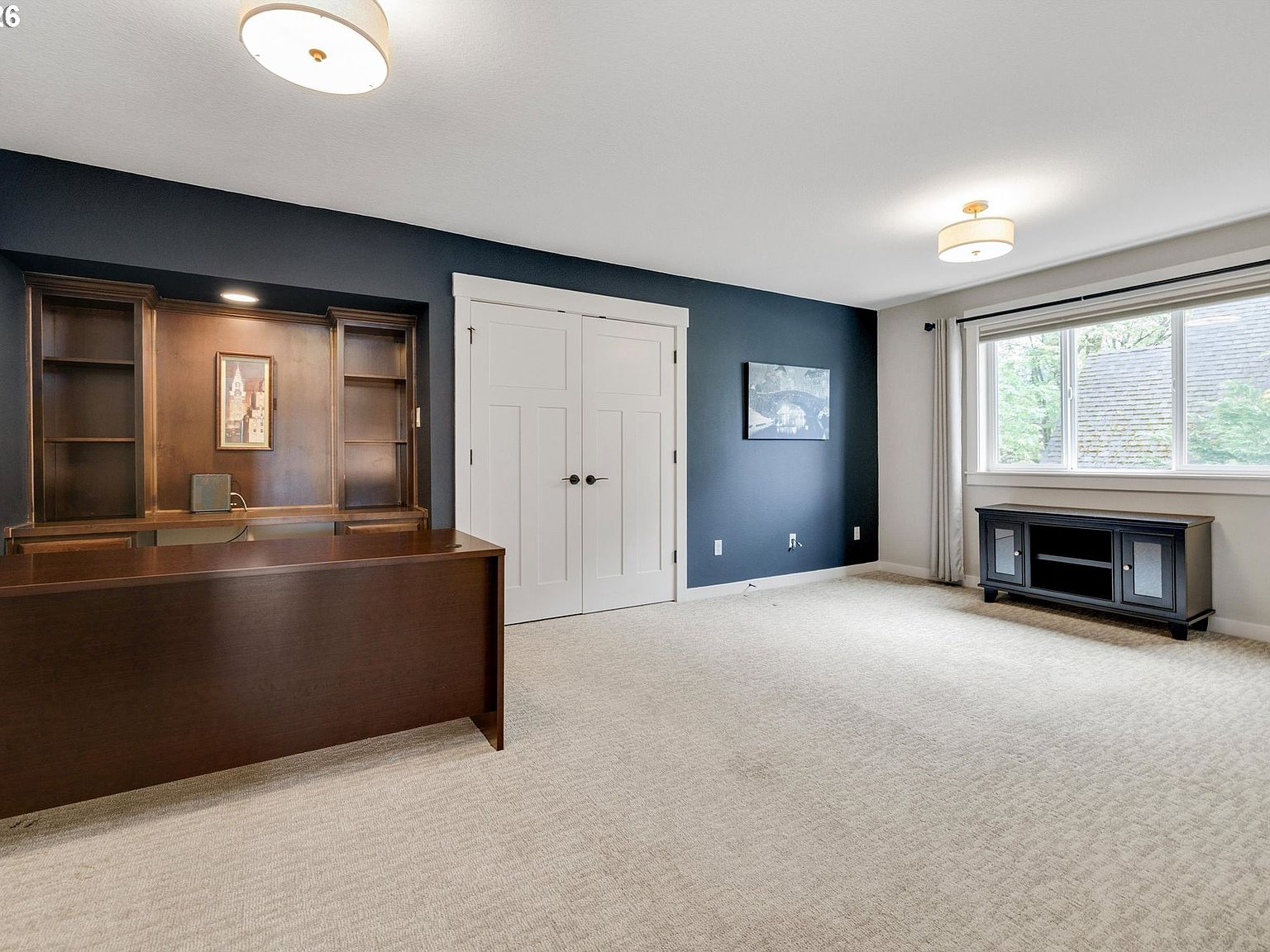 Spacious fourth bedroom configured as a home office with built-ins