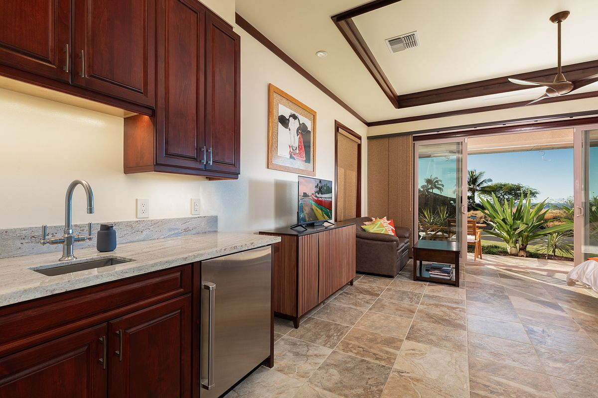 Guest suite living room featuring built-in beverage center.