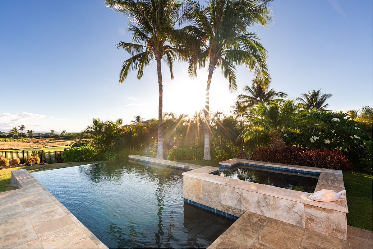 Clear view of the sparkling infinity swimming pool and raised luxury spa.