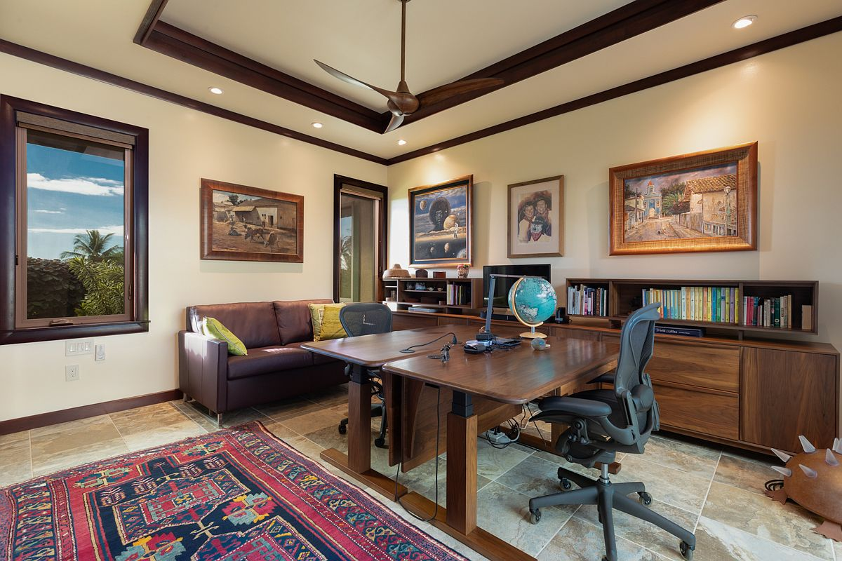 Private home office/study with travertine floors and wood trim.