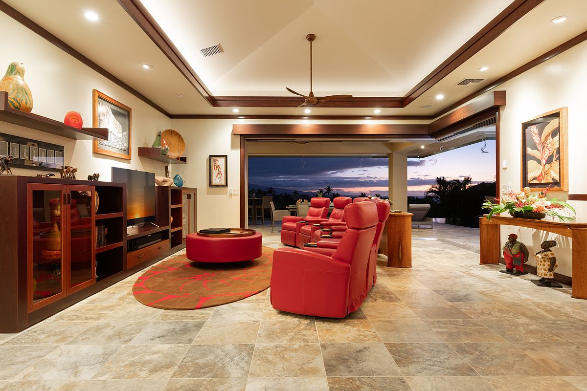 Open-concept living room at sunset with pocketing glass sliding doors framing a vibrant twilight sky and private patio transition.