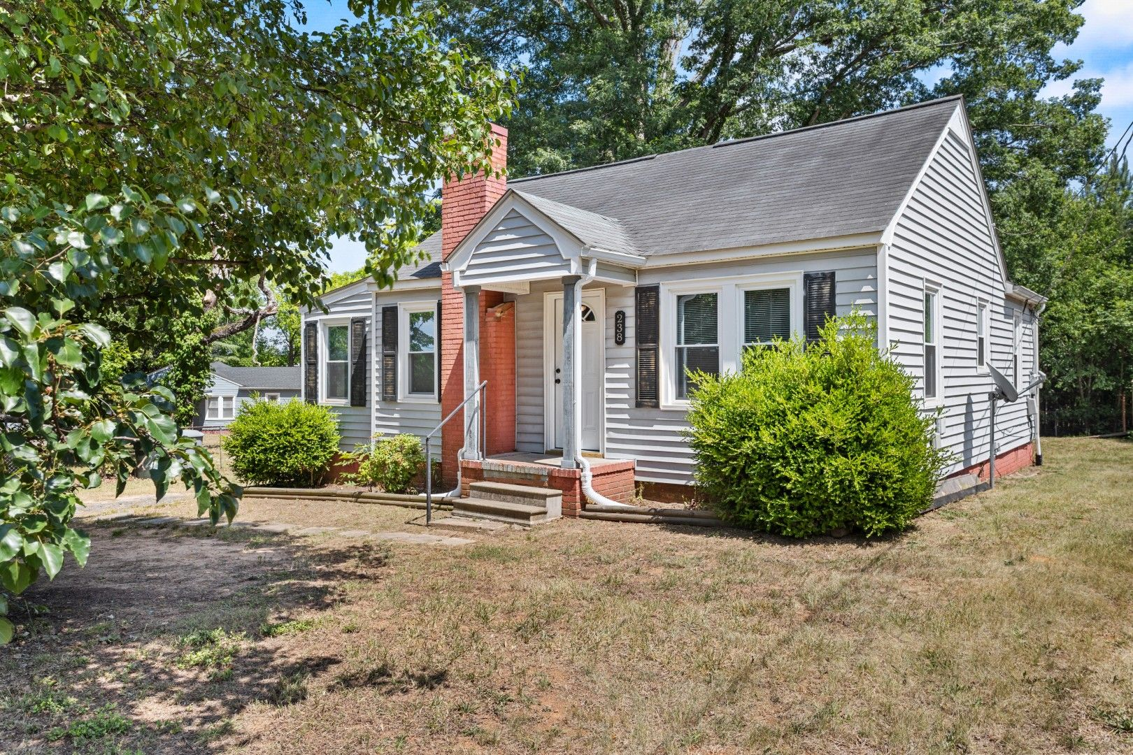 The side profile of 238 Underwood St cottage in daylight with clear sky