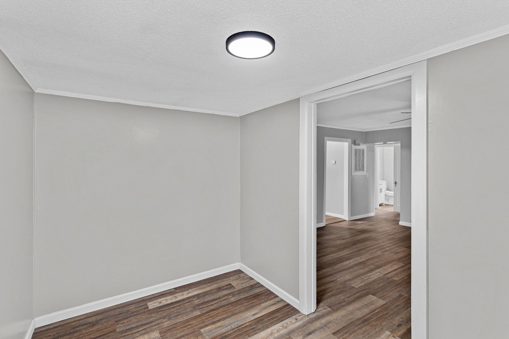 Versatile empty bonus room alcove looking into other rooms