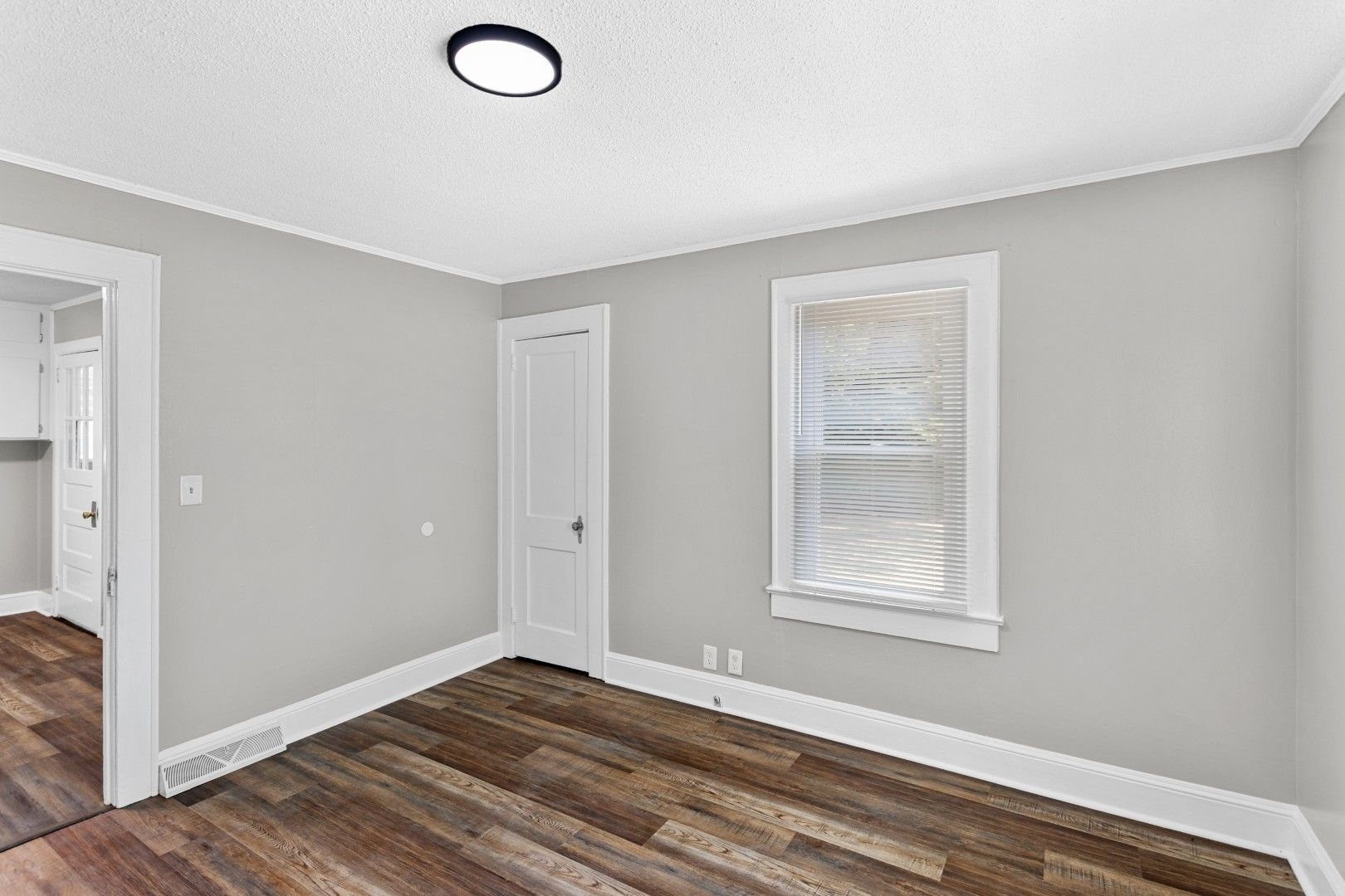 Third vacant bedroom with ceiling light and double window