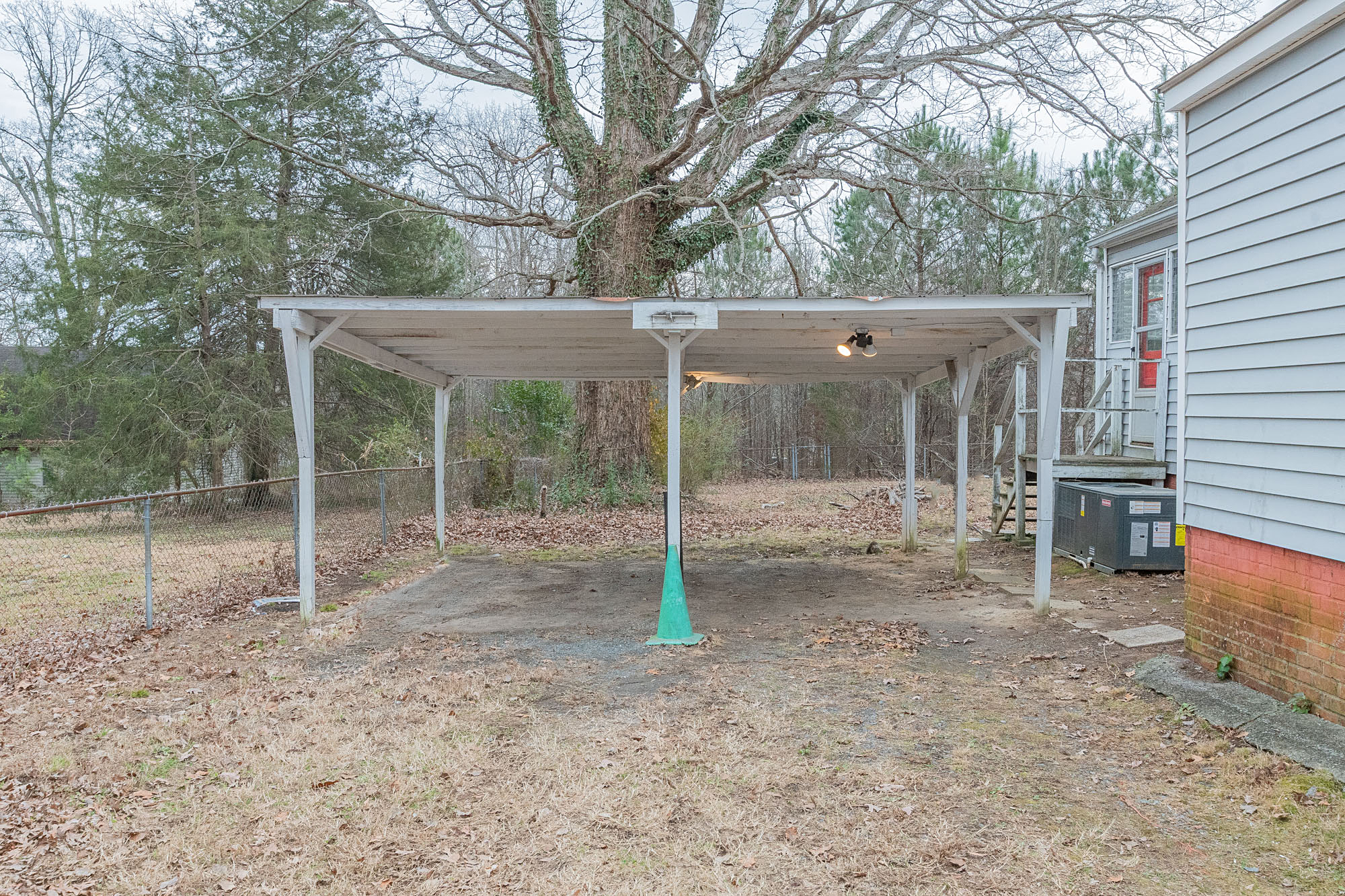 Detached open-sided wooden carport in the backyard