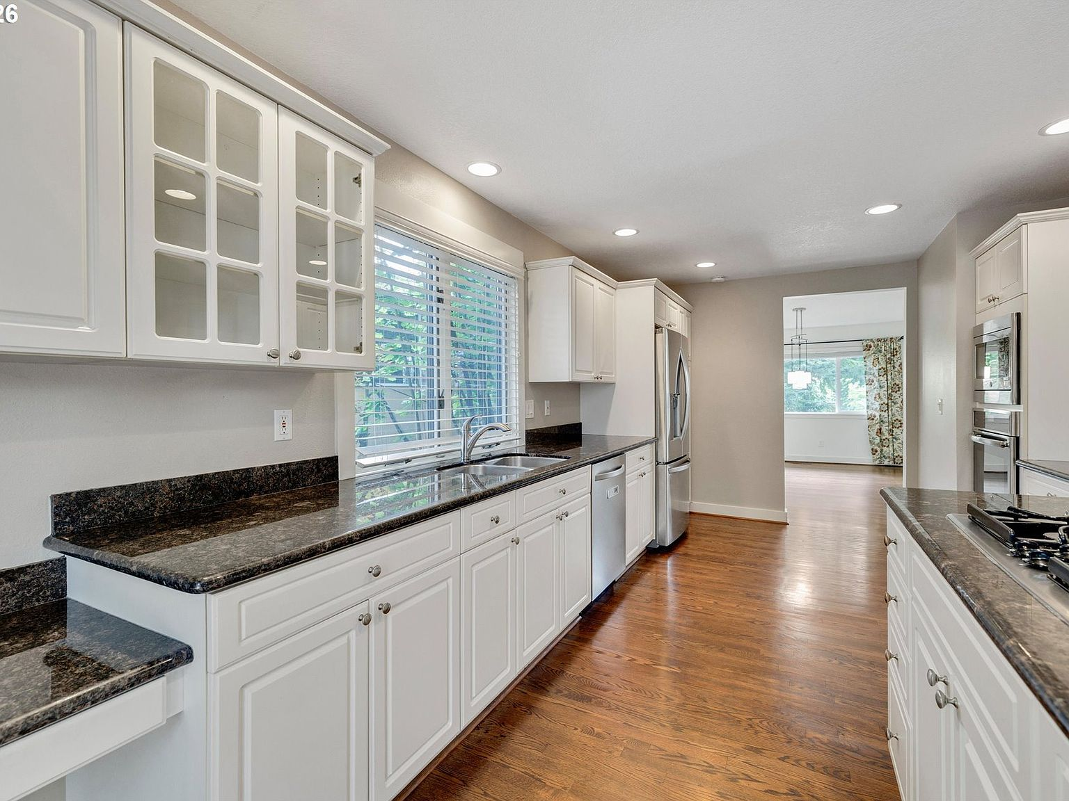 Kitchen with white shaker cabinetry and stainless steel appliances