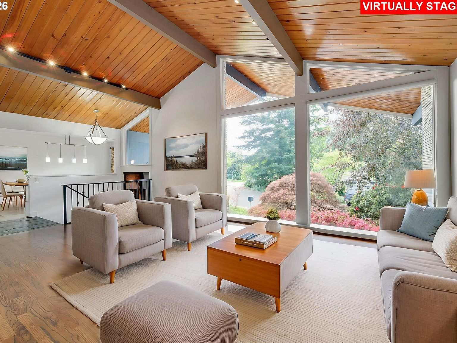 Vaulted living room with exposed beams and hardwood floors
