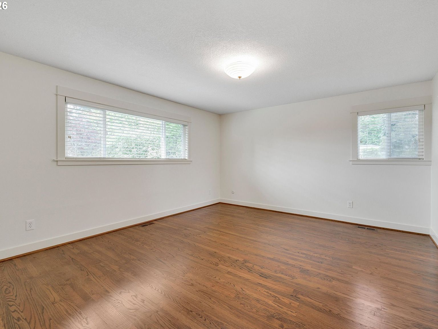 Bedroom or bonus room with hardwood flooring