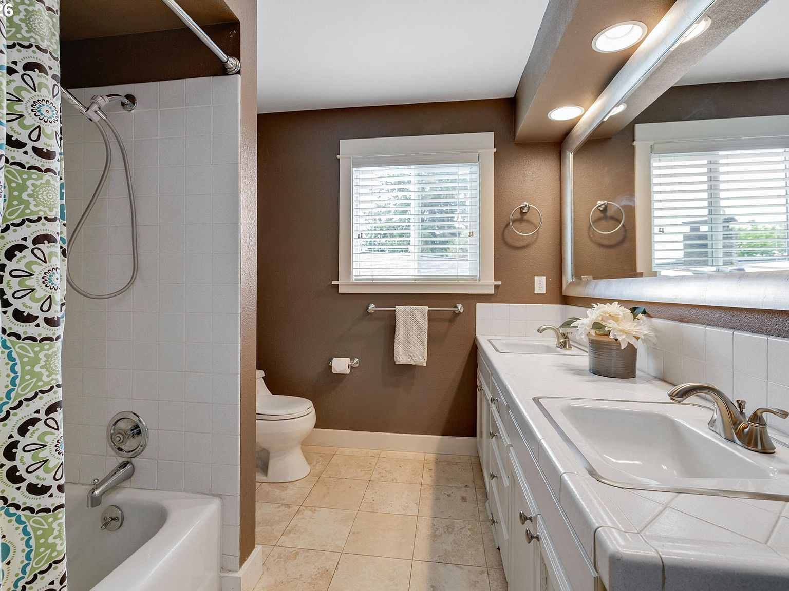Bathroom with double vanity and tub-shower combo