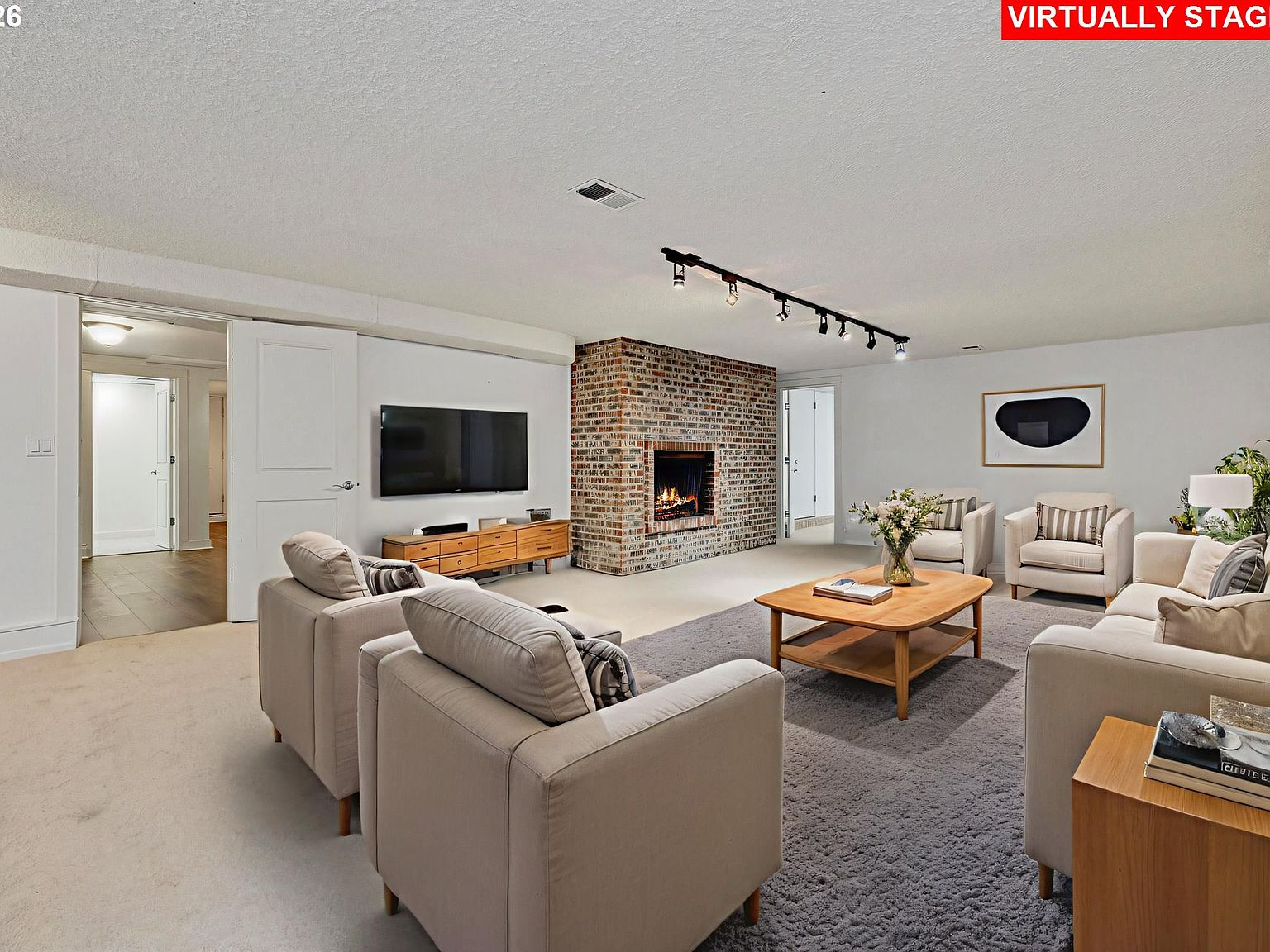 Basement living room with red-brick fireplace