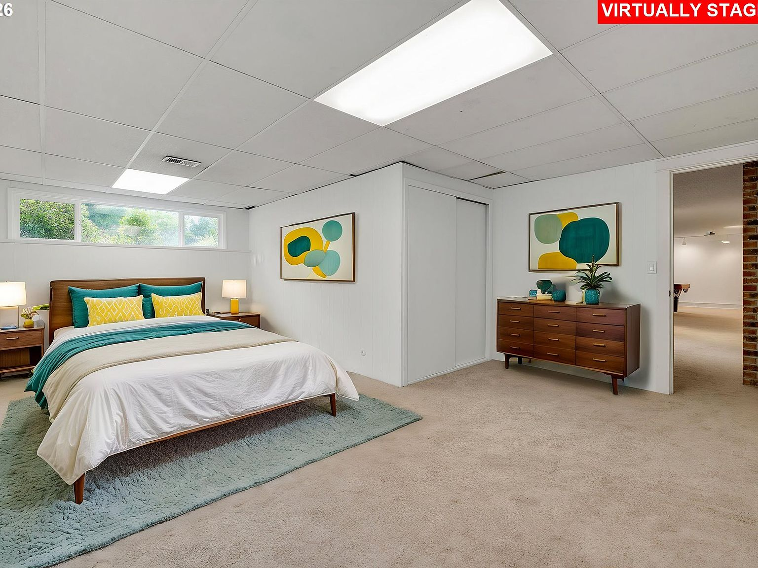Basement bedroom with drop ceiling and carpet