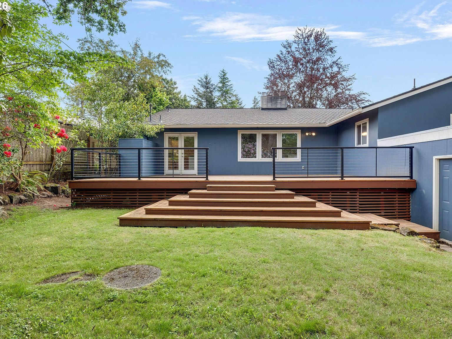 Backyard deck with steps leading to lawn