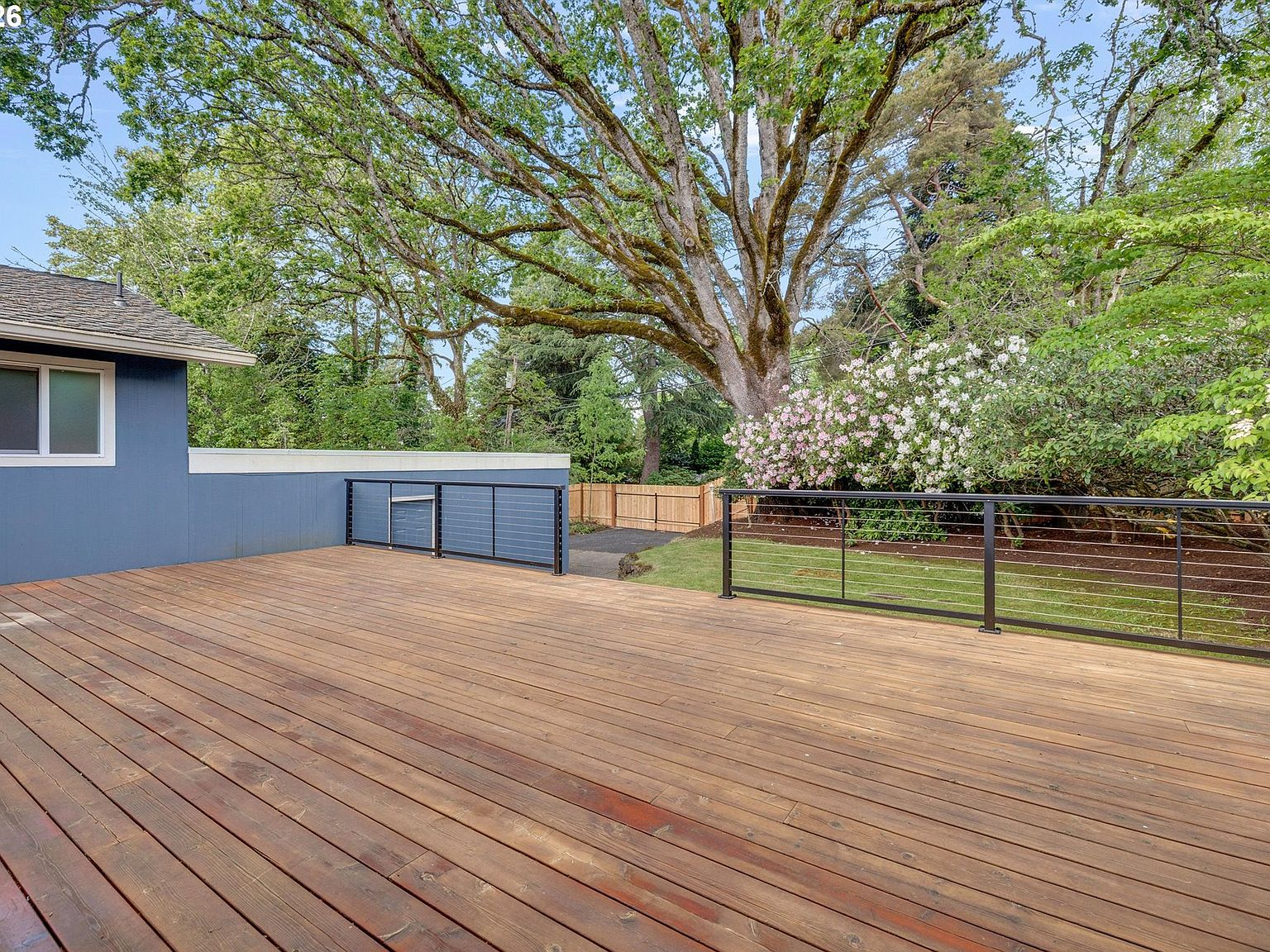 Large wooden entertaining deck with modern black railing