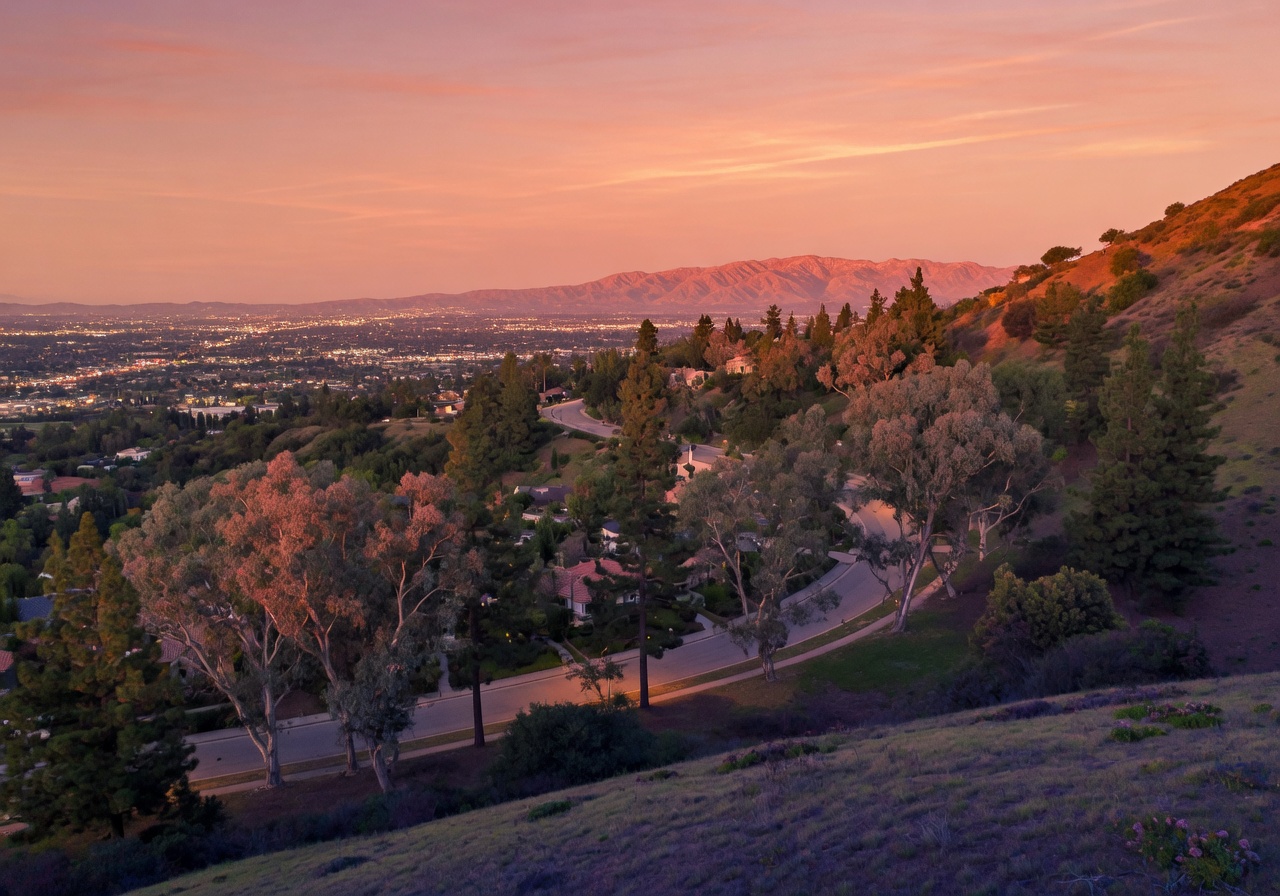 Sunset view from the heights of Raymond Hills in Fullerton California overlooking majestic trees and hills