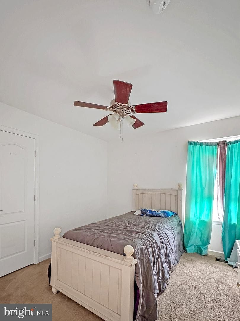 Cozy guest bedroom space on the upper floor with classic closet doors