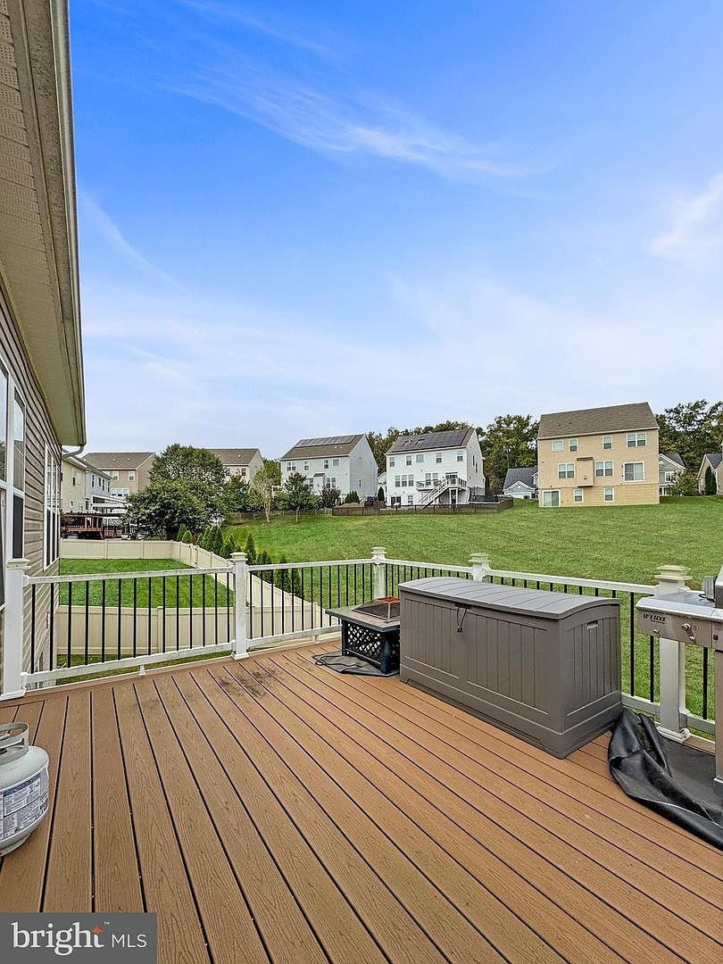 View from the elevated composite deck showing vinyl railings and a clear look over the fenced backyard