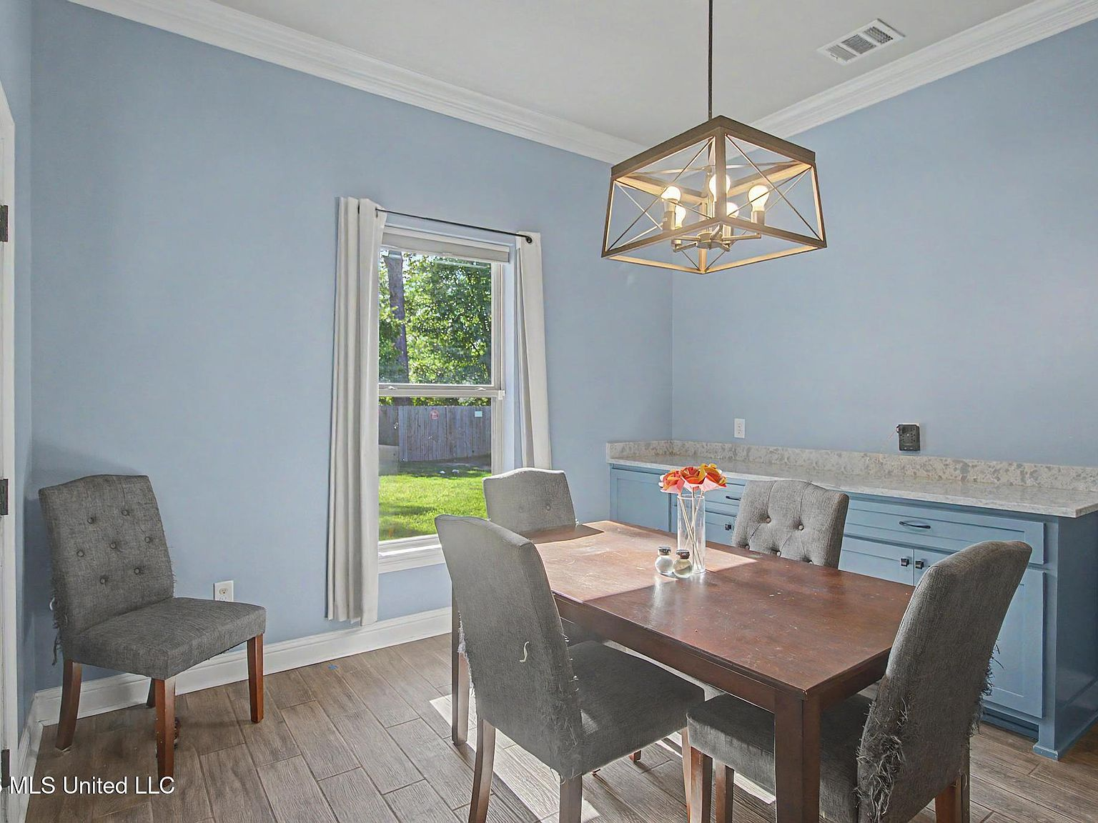 Dining area showcasing integrated blue buffet cabinet