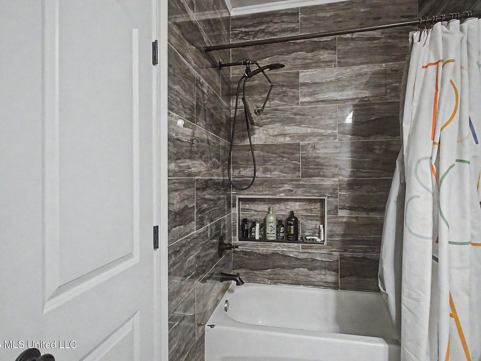 Tub and shower combo with dark tile work