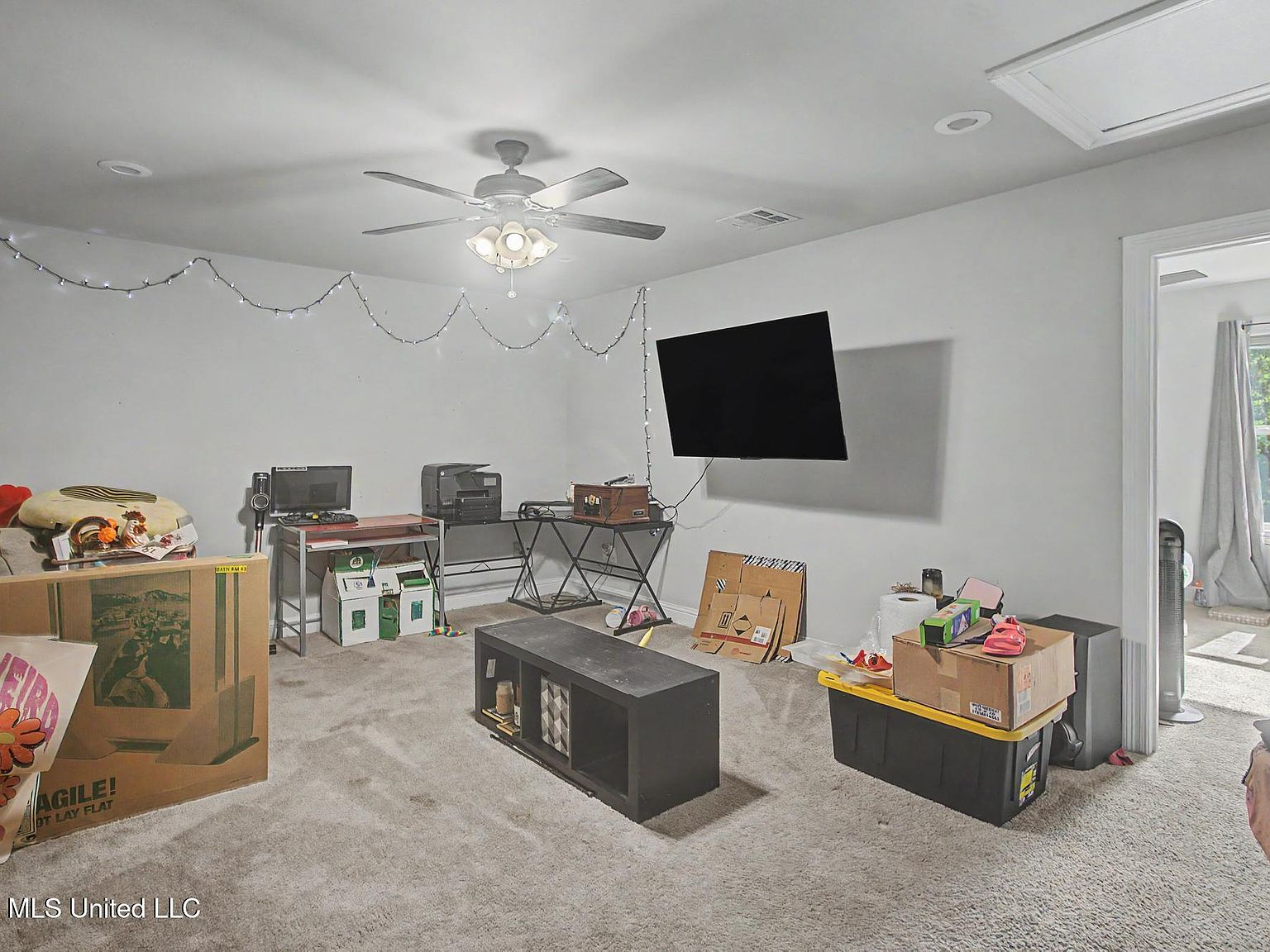 Expansive carpeted upstairs bonus room offering space for a home office, gym, or dynamic media den